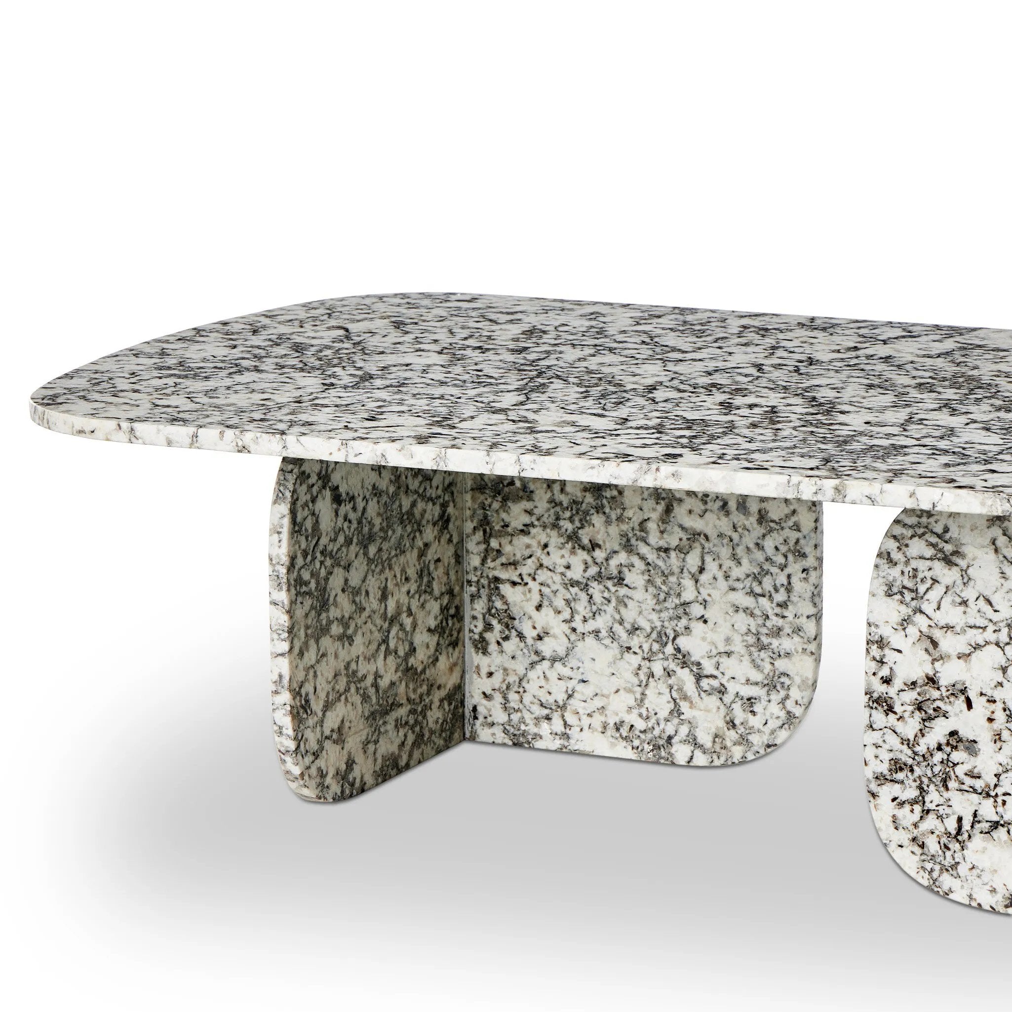 Speckled black marble shapes a unique coffee table with softened corners and subtle Eighties vibes.Collection: Marlo Amethyst Home provides interior design, new home construction design consulting, vintage area rugs, and lighting in the Laguna Beach metro area.