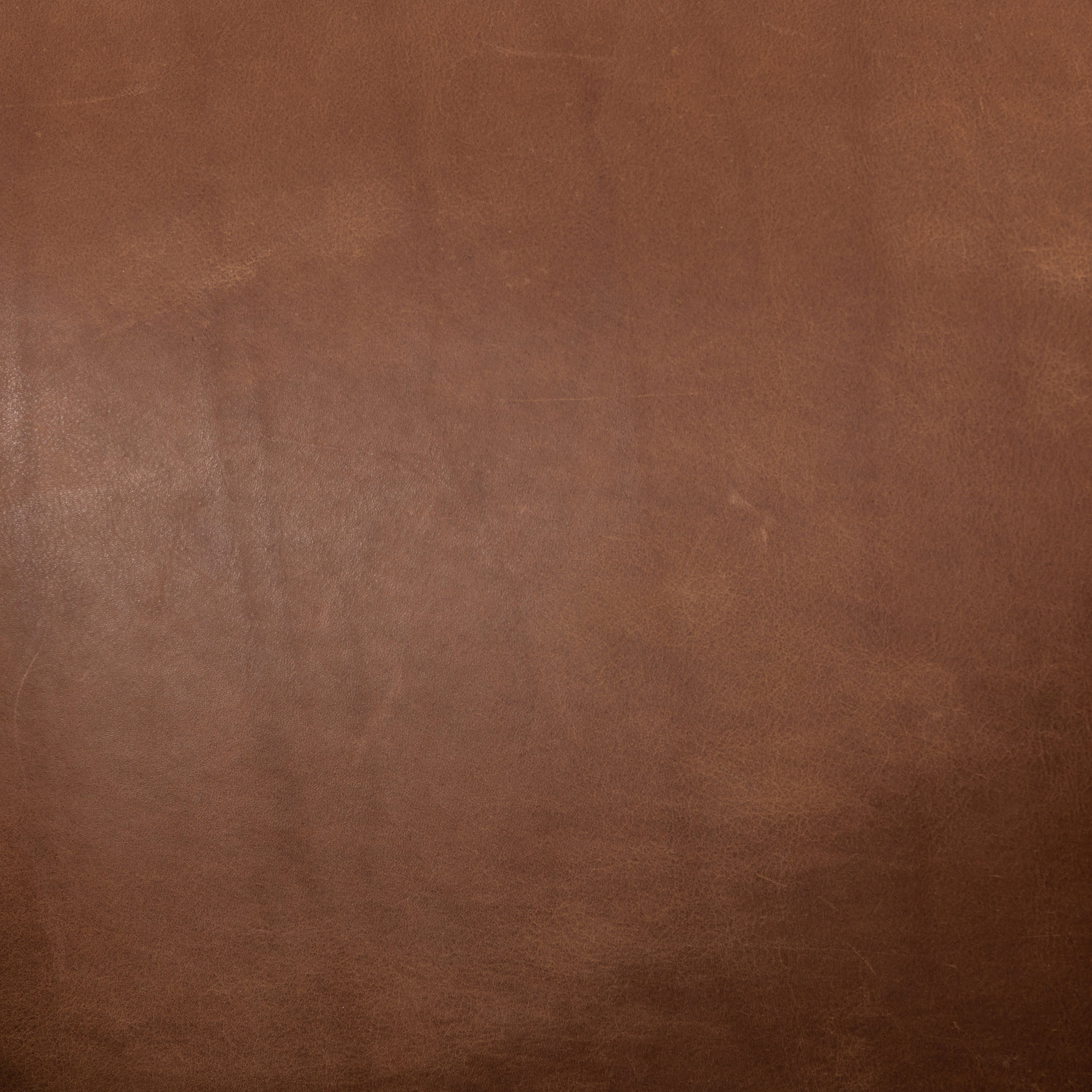 Featuring Reggie Heirloom Sienna Chair by Four Hands at Amethyst Home. Oversized cushioning brings a Brazilian midcentury feel to this vintage-inspired chair. Designed with cushion-wrapped slanted arms, fixed cushioning with a deep sit and narrow legs reminiscent of midcentury style. Sourced from one of the oldest family-owned tanneries in Italy's Bassano del Grappa, heirloom lea. Amethyst Home provides interior design, new construction, custom furniture, and area rugs in the Calabasas metro area.