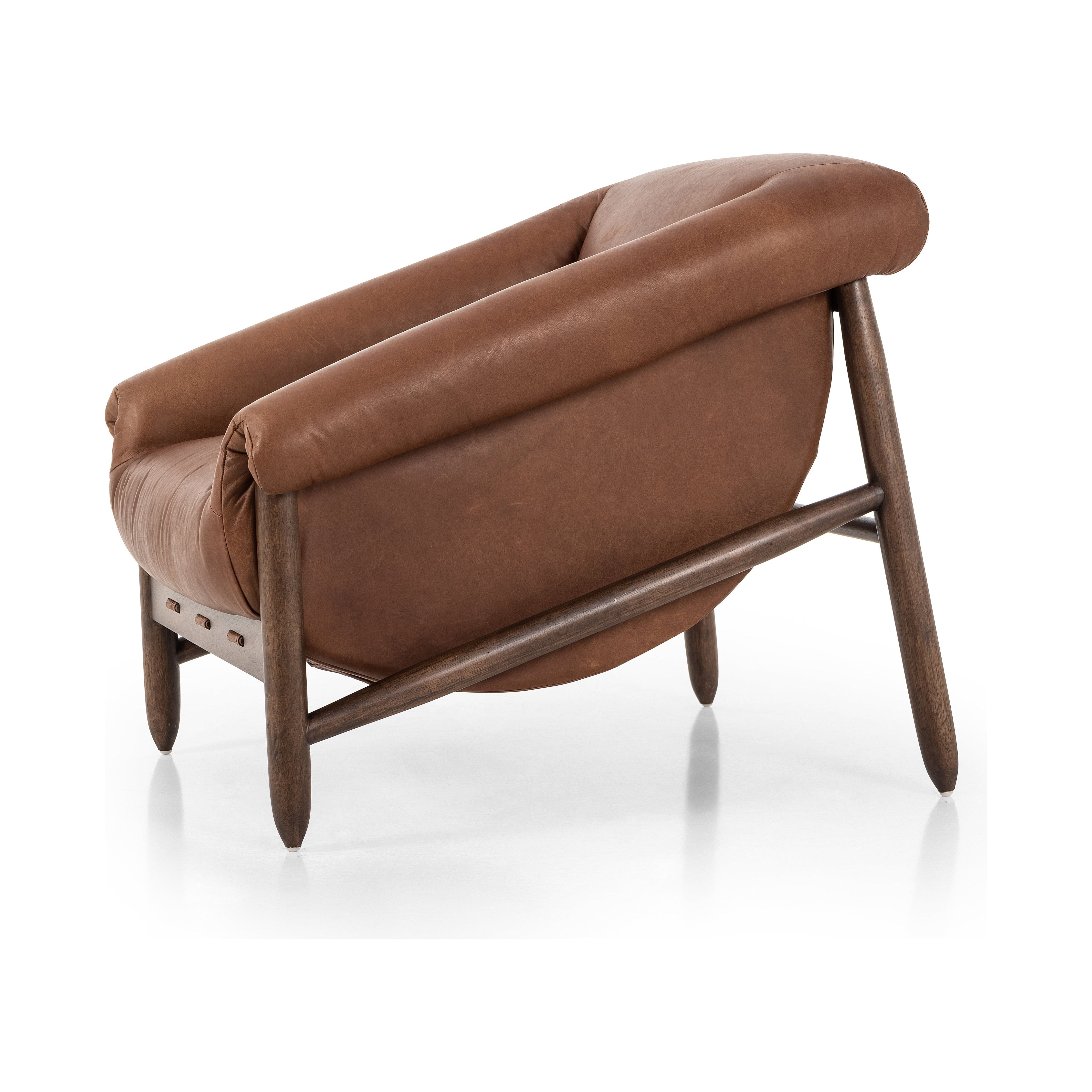 Featuring Reggie Heirloom Sienna Chair by Four Hands at Amethyst Home. Oversized cushioning brings a Brazilian midcentury feel to this vintage-inspired chair. Designed with cushion-wrapped slanted arms, fixed cushioning with a deep sit and narrow legs reminiscent of midcentury style. Sourced from one of the oldest family-owned tanneries in Italy's Bassano del Grappa, heirloom lea. Amethyst Home provides interior design, new construction, custom furniture, and area rugs in the Charlotte metro area.