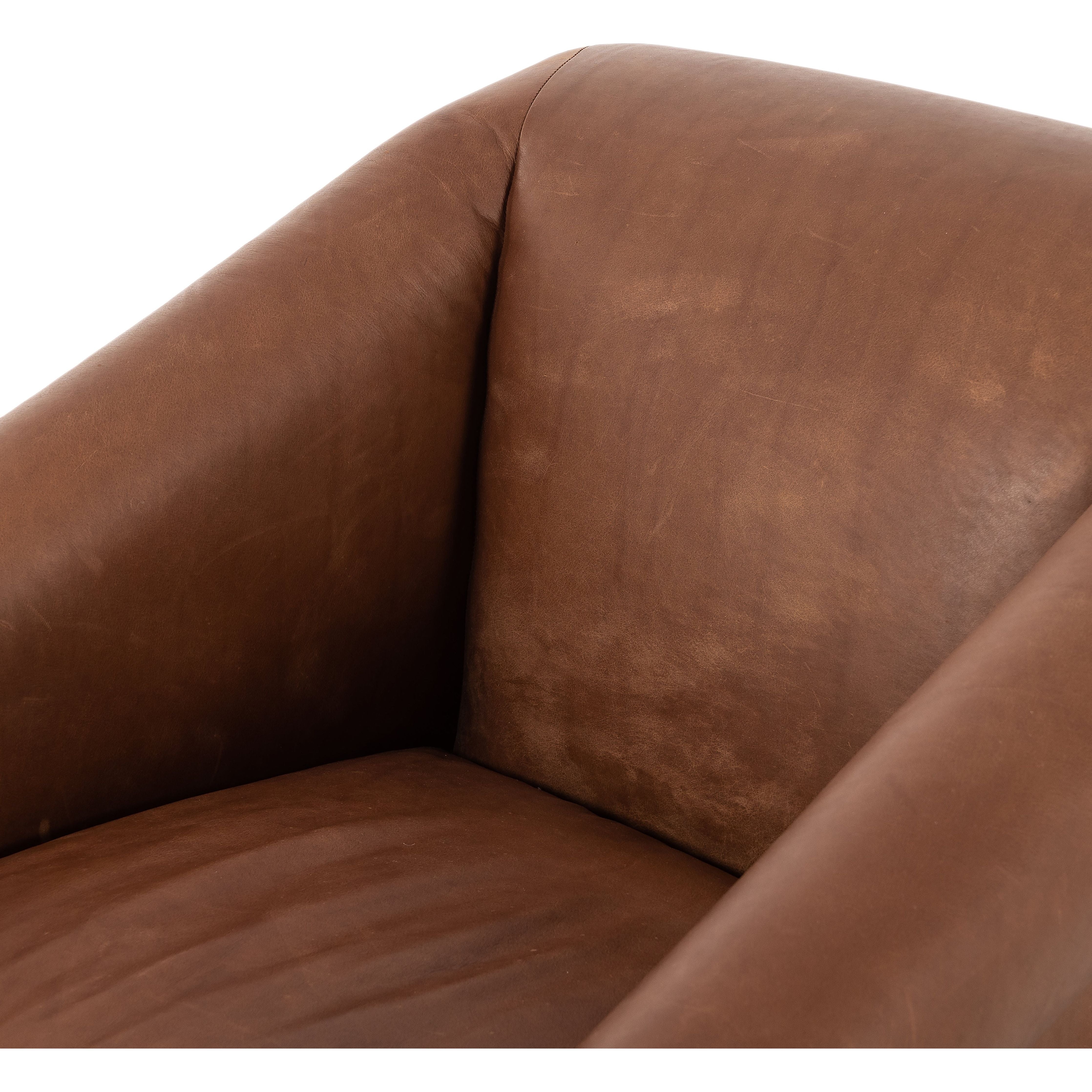 Featuring Reggie Heirloom Sienna Chair by Four Hands at Amethyst Home. Oversized cushioning brings a Brazilian midcentury feel to this vintage-inspired chair. Designed with cushion-wrapped slanted arms, fixed cushioning with a deep sit and narrow legs reminiscent of midcentury style. Sourced from one of the oldest family-owned tanneries in Italy's Bassano del Grappa, heirloom leather. Amethyst Home provides interior design, new construction, custom furniture, and area rugs in the Omaha metro area.