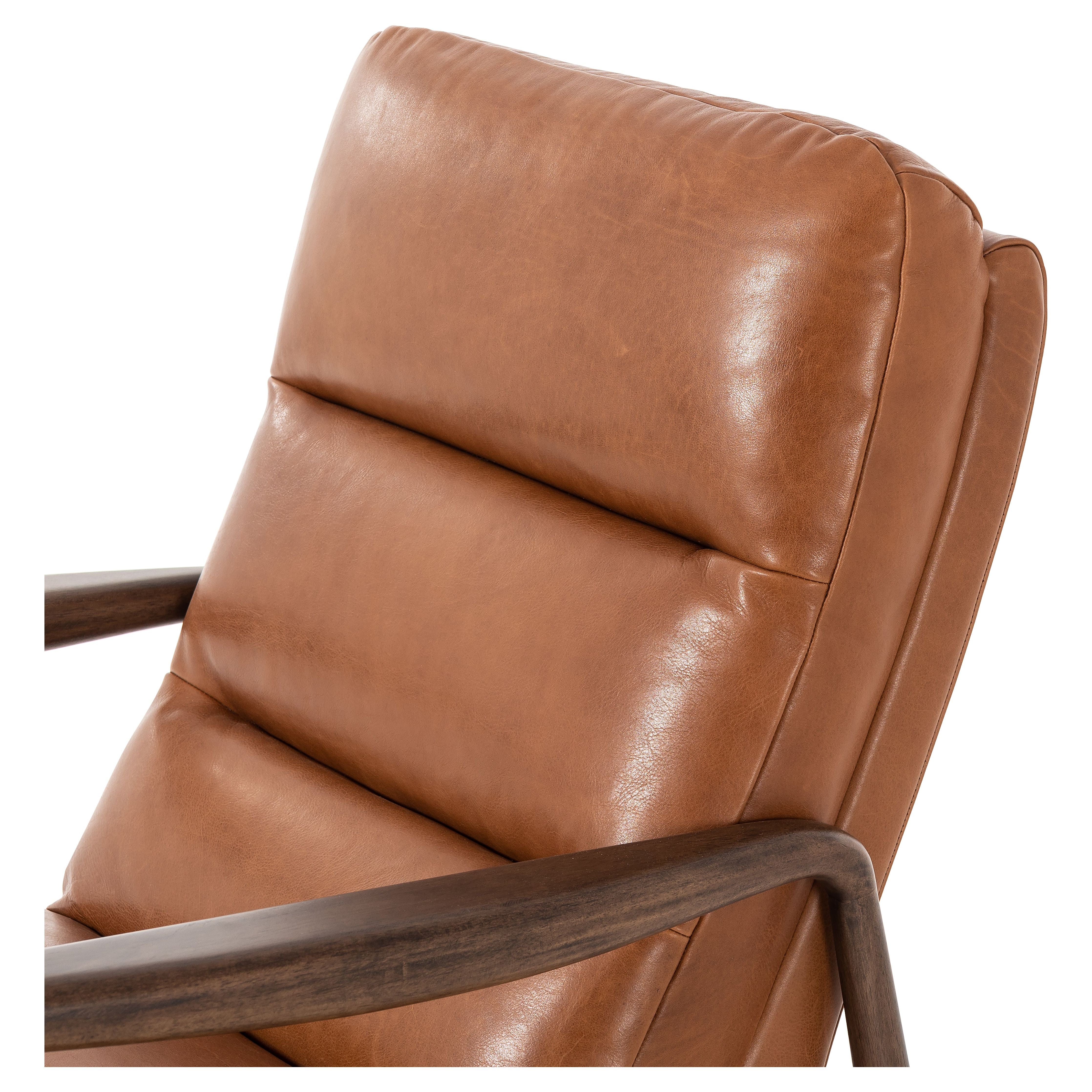 A sleek seat with hidden push-back reclining functionality. This midcentury-inspired recliner features wide chunky channeling paired with slim paddle arms and a tapered wood frame. Designed with a high seat and high back for extra comfy support. Upholstered in a timeless tobacco-hued leather made in a family-owned tannery in Thailand. Amethyst Home provides interior design, new construction, custom furniture, and area rugs in the Boston metro area.