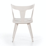 This new take on the mid-century Windsor chair, the Ripley Off White Dining Chair has a bowed, sculptural silhouette. The dining chair is done in an off-white finish to highlight the natural grain of weathered oak. Amethyst Home provides interior design, new construction, custom furniture, and rugs for the Austin, Texas metro area.
