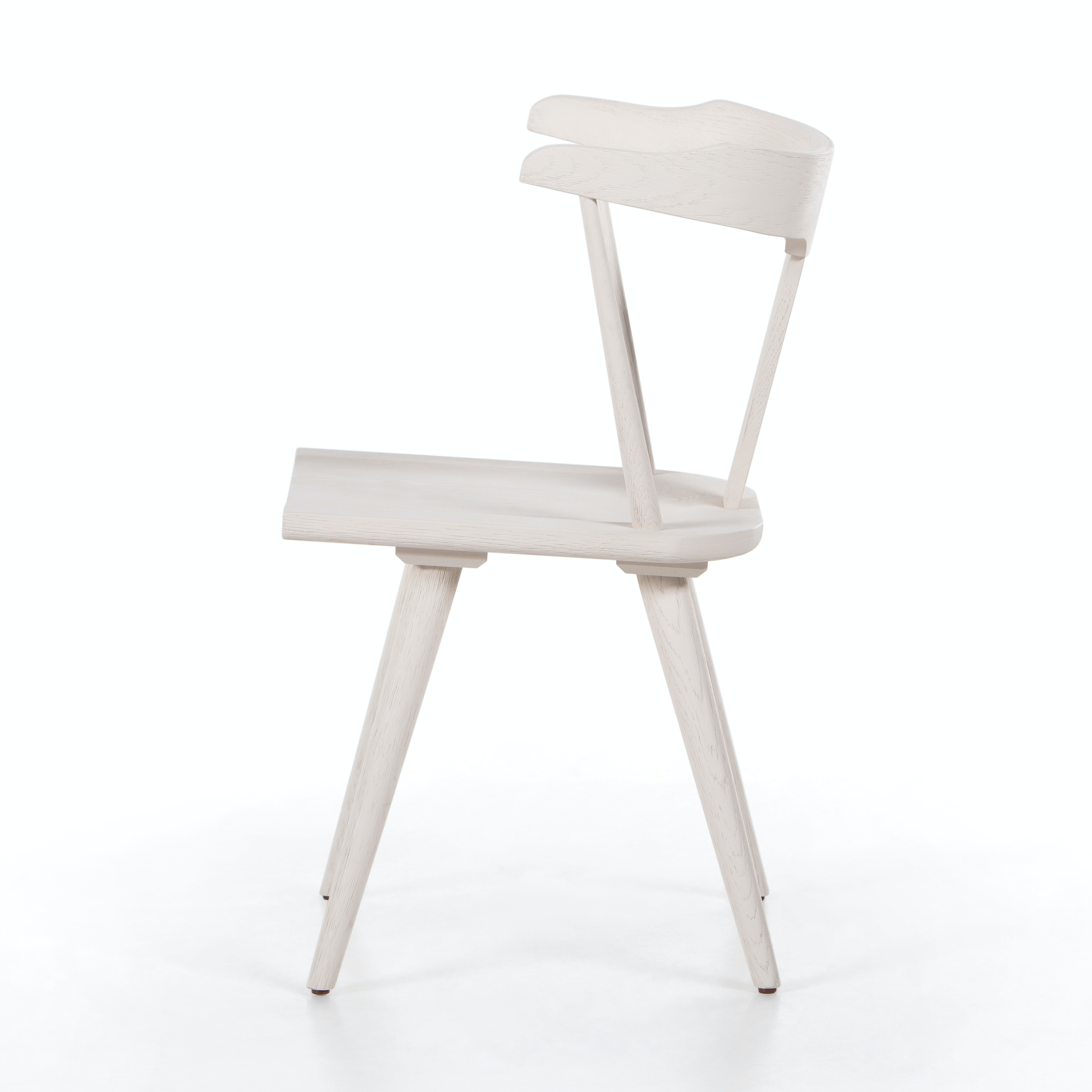This new take on the mid-century Windsor chair, the Ripley Off White Dining Chair has a bowed, sculptural silhouette. The dining chair is done in an off-white finish to highlight the natural grain of weathered oak. Amethyst Home provides interior design, new construction, custom furniture, and rugs for the Winter Park, Florida metro area.