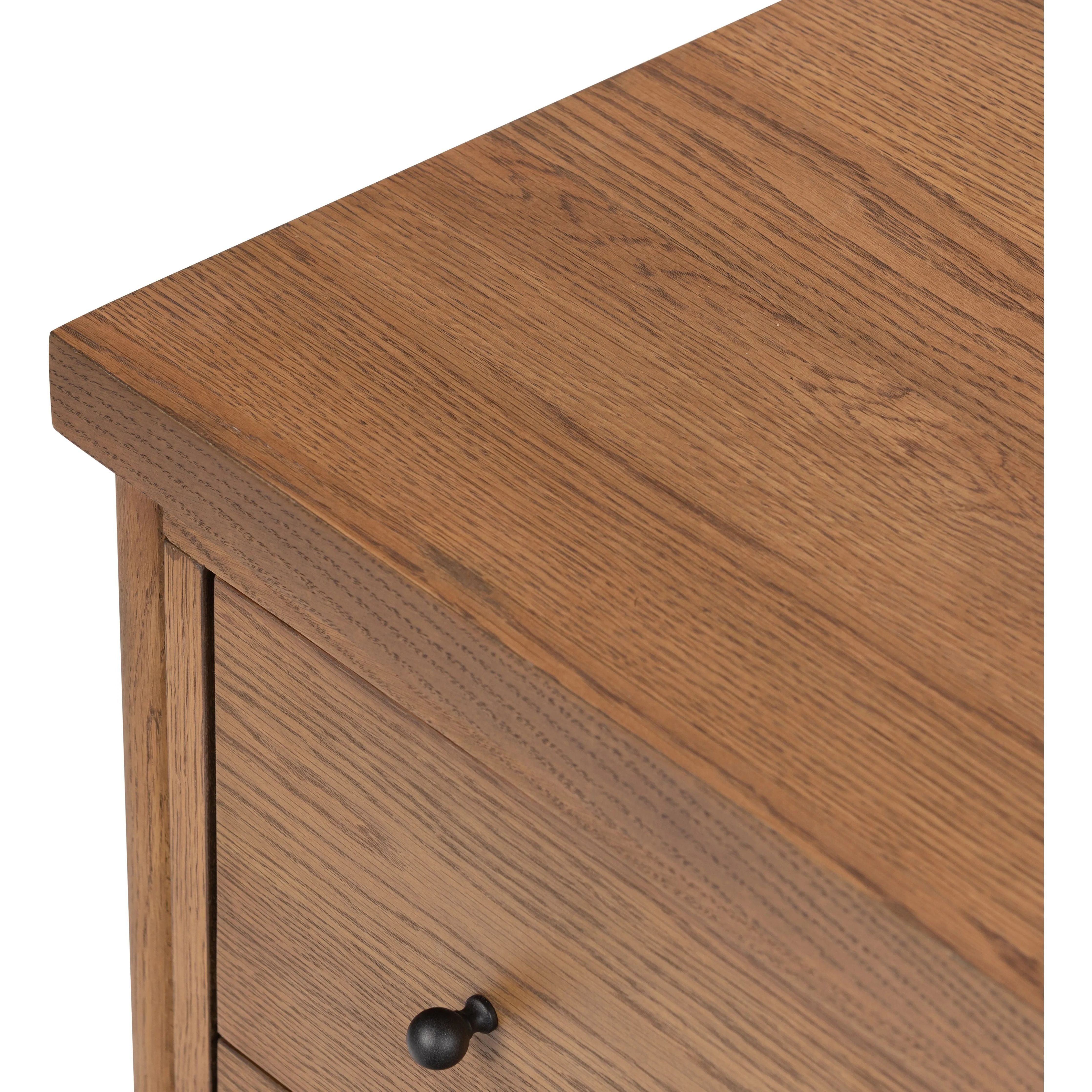 Rounded, chunky dowel legs in an amber oak finish support the overhang top of of this nightstand. Two drawers provide ample storage, finished with simple gunmetal hardware Amethyst Home provides interior design, new home construction design consulting, vintage area rugs, and lighting in the Kansas City metro area.