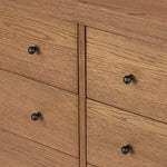 Rounded, chunky dowel legs in an amber oak finish support the overhang top of of this dresser. Six drawers provide ample storage, finished with simple gunmetal hardware Amethyst Home provides interior design, new home construction design consulting, vintage area rugs, and lighting in the Seattle metro area.