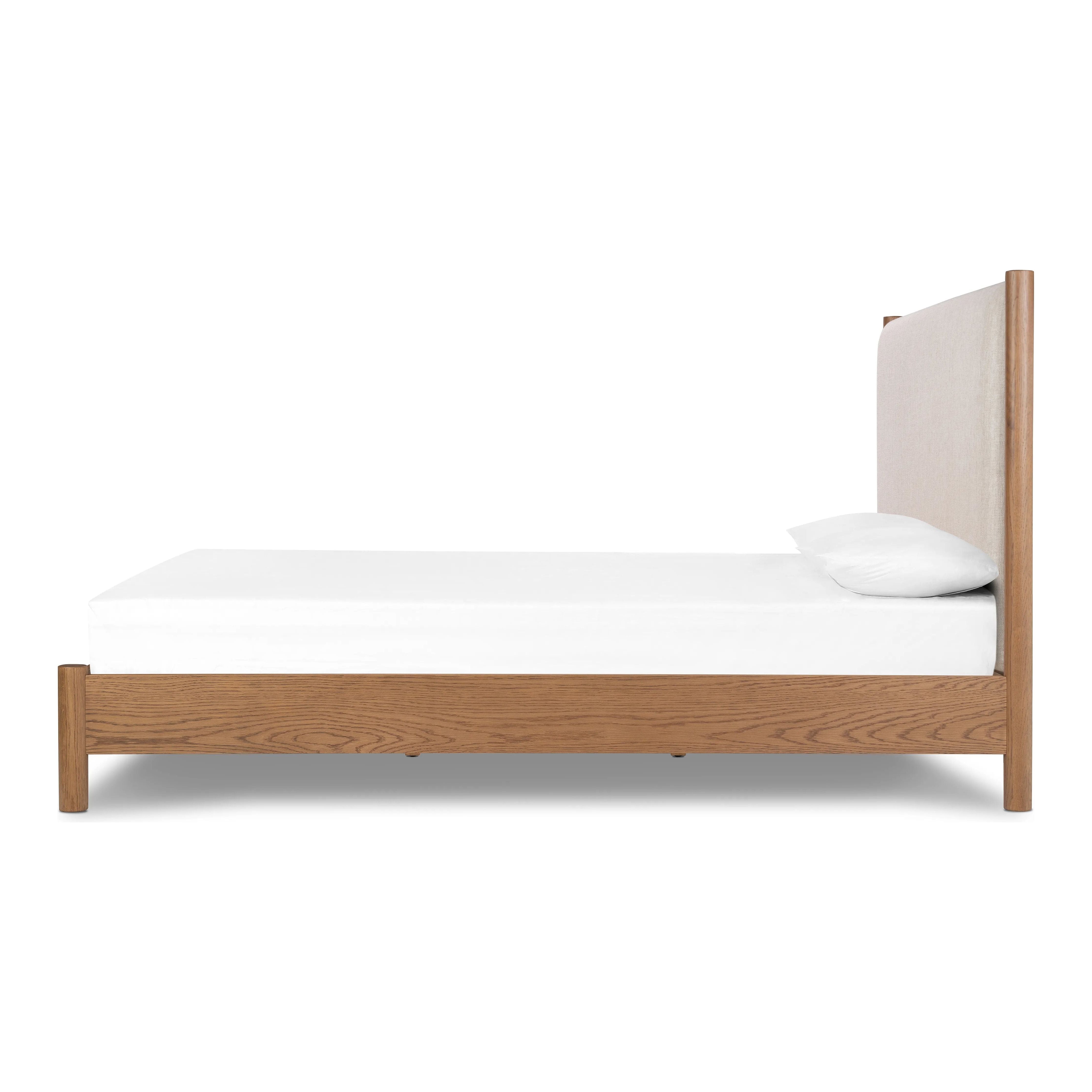 Rounded, chunky dowel legs in an amber oak finish frame the neutral, linen-like upholstered headboard of this bed frame.Collection: Bolto Amethyst Home provides interior design, new home construction design consulting, vintage area rugs, and lighting in the Portland metro area.