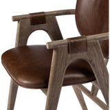 Inspired by Danish midcentury styles, this dining armchair pairs angular framework with soft, rounded seat panels. Seating and arm straps finished in top-grain leather exclusive to Four Hands. Amethyst Home provides interior design, new construction, custom furniture, and area rugs in the Laguna Beach metro area.