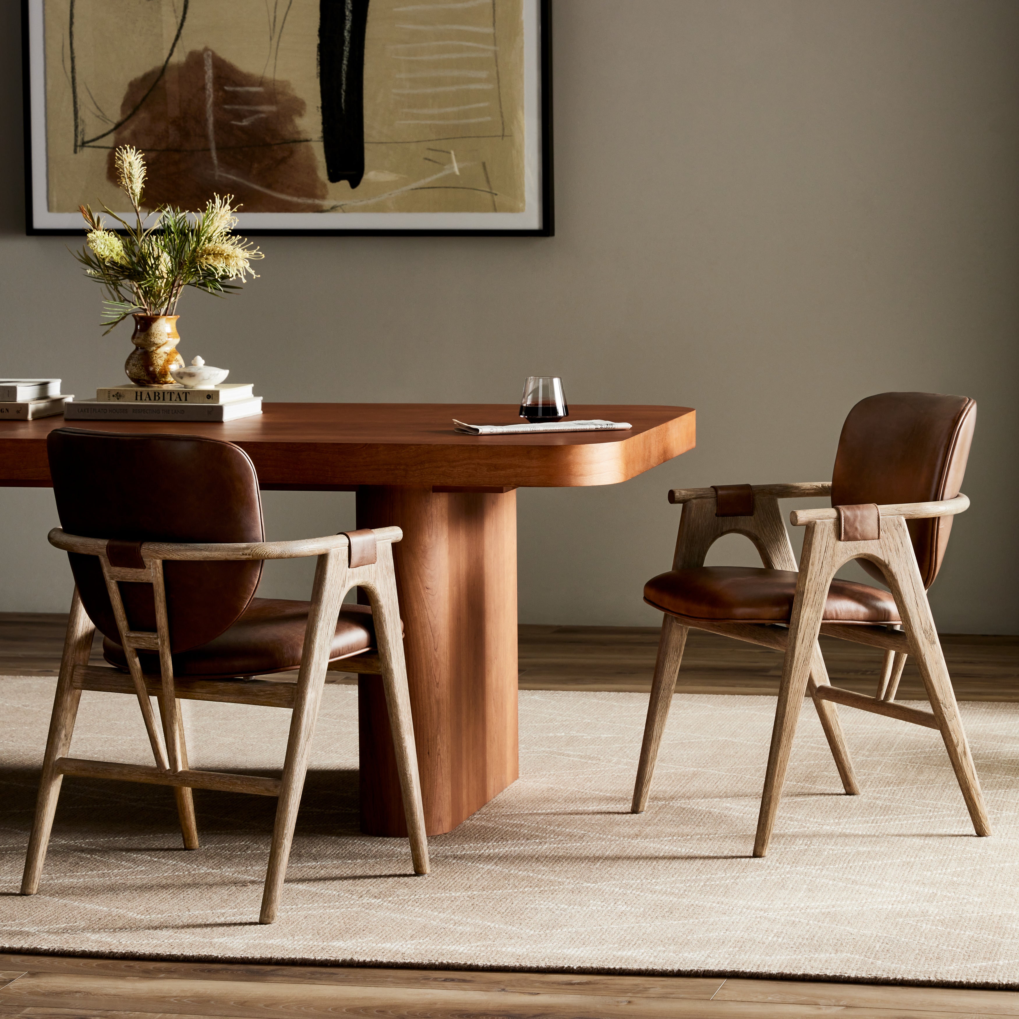 Inspired by Danish midcentury styles, this dining armchair pairs angular framework with soft, rounded seat panels. Seating and arm straps finished in top-grain leather exclusive to Four Hands. Amethyst Home provides interior design, new construction, custom furniture, and area rugs in the Monterey metro area.