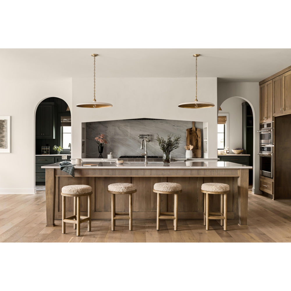 Featuring Saldino Stool by Four Hands at Amethyst Home. Bring a textural touch to the counter with the Saldino stool. Blonde-finished solid parawood supports rounded seating of soft beige shearling for comfort and style alike.
Overall Dimensions: 17"W x 17"L x 26"HColors: Blonde Nettlewood, Beige ShearlingMaterials: Solid Nettlewood, Shearling Weight: 15..  Amethyst Home provides interior design, new home construction design consulting, vintage area rugs, and lighting in the Des Moines metro area.