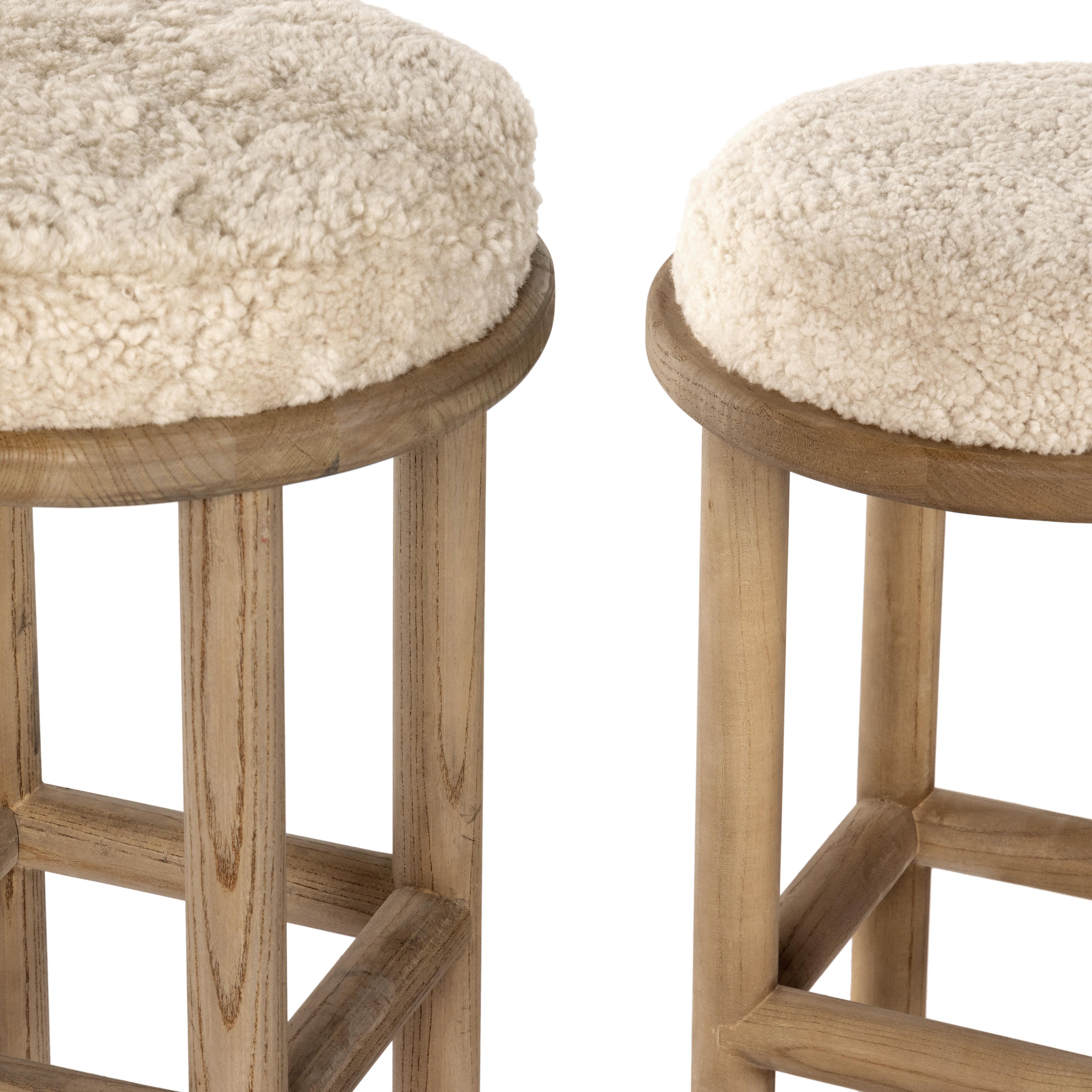 Bring a textural touch to the counter with the Saldino stool. Blonde-finished solid parawood supports rounded seating of soft beige shearling for comfort and style alike. Amethyst Home provides interior design, new home construction design consulting, vintage area rugs, and lighting in the Scottsdale metro area.