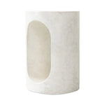 Made from textured white concrete, a cylinder shaped end table features a pill-shaped cutout for a light look. Subtle mottling adds a hint of texture.Collection: Chandle Amethyst Home provides interior design, new home construction design consulting, vintage area rugs, and lighting in the Laguna Beach metro area.
