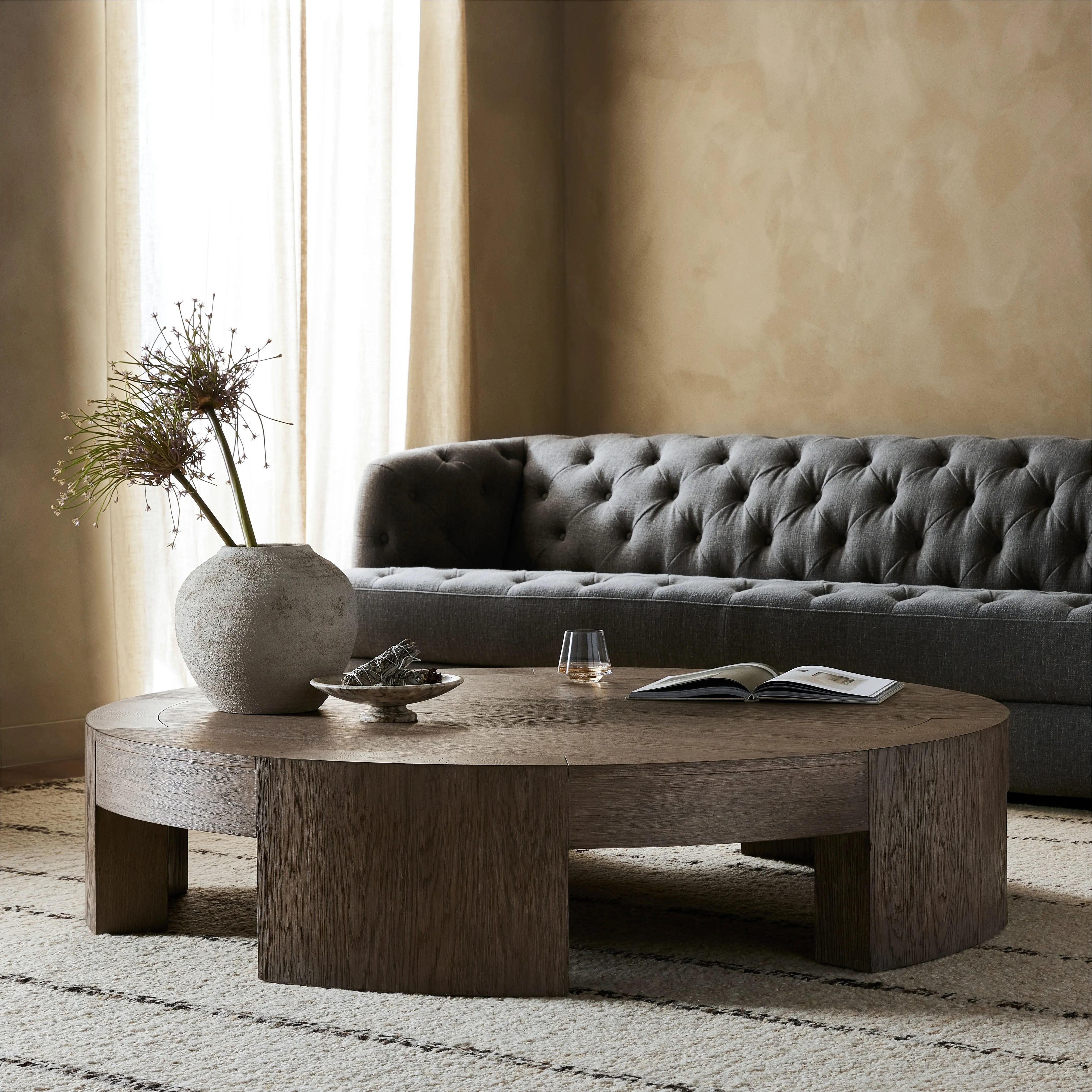 A simple stunner. This large coffee table features exposed joinery from five thick, gently curved legs. Crafted from a beautiful oak veneer with exposed graining throughout.Collection: Irondal Amethyst Home provides interior design, new home construction design consulting, vintage area rugs, and lighting in the Austin metro area.