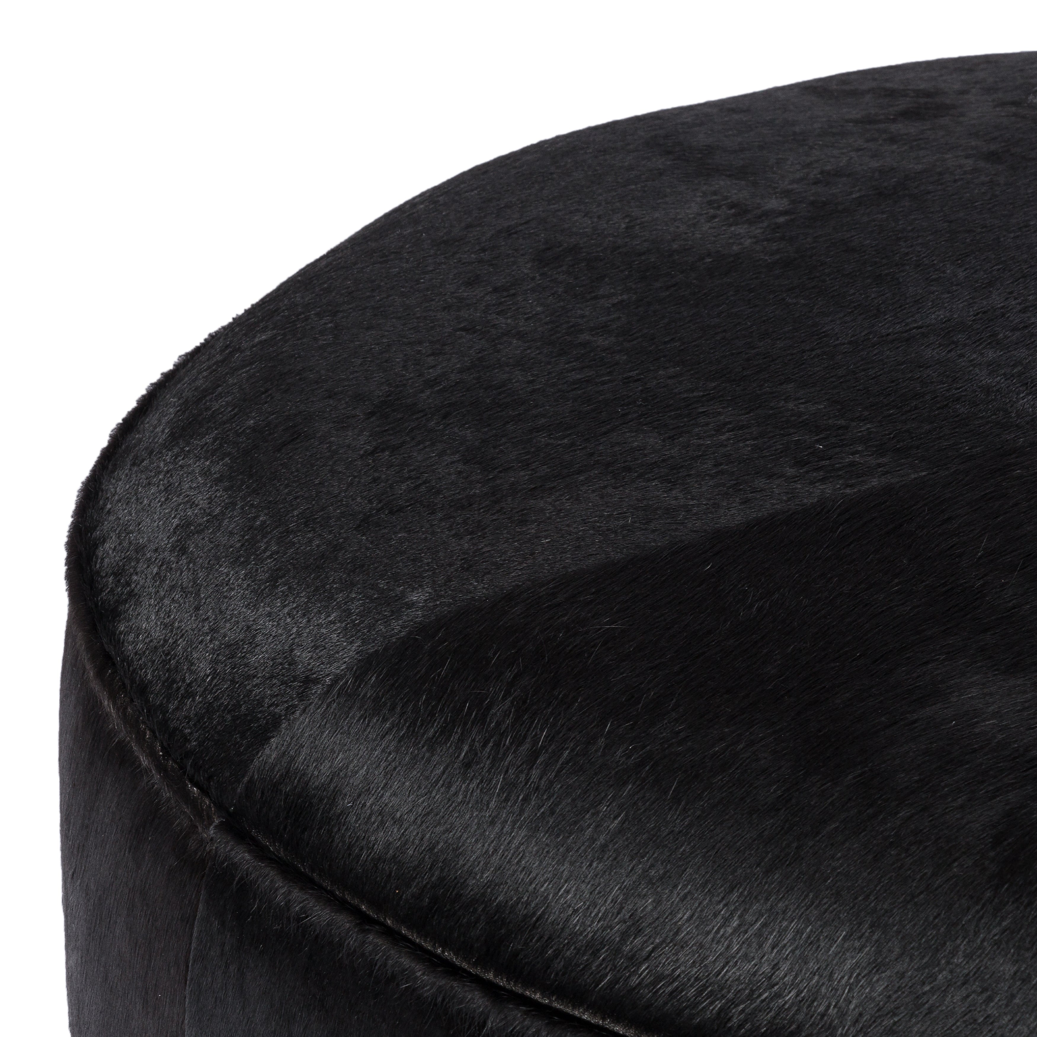 This large, round ottoman of textural hair-on hide brings with it a hip retro vibe as a coffee table or extra seating.  Covered in soft and luminous black hair-on hide, which is naturally warm and textural with authentic highlights. Amethyst Home provides interior design, new construction, custom furniture, and area rugs in the Des Moines metro area.