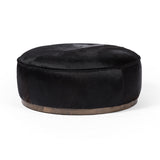 This large, round ottoman of textural hair-on hide brings with it a hip retro vibe as a coffee table or extra seating.  Covered in soft and luminous black hair-on hide, which is naturally warm and textural with authentic highlights. Amethyst Home provides interior design, new construction, custom furniture, and area rugs in the Washington metro area.