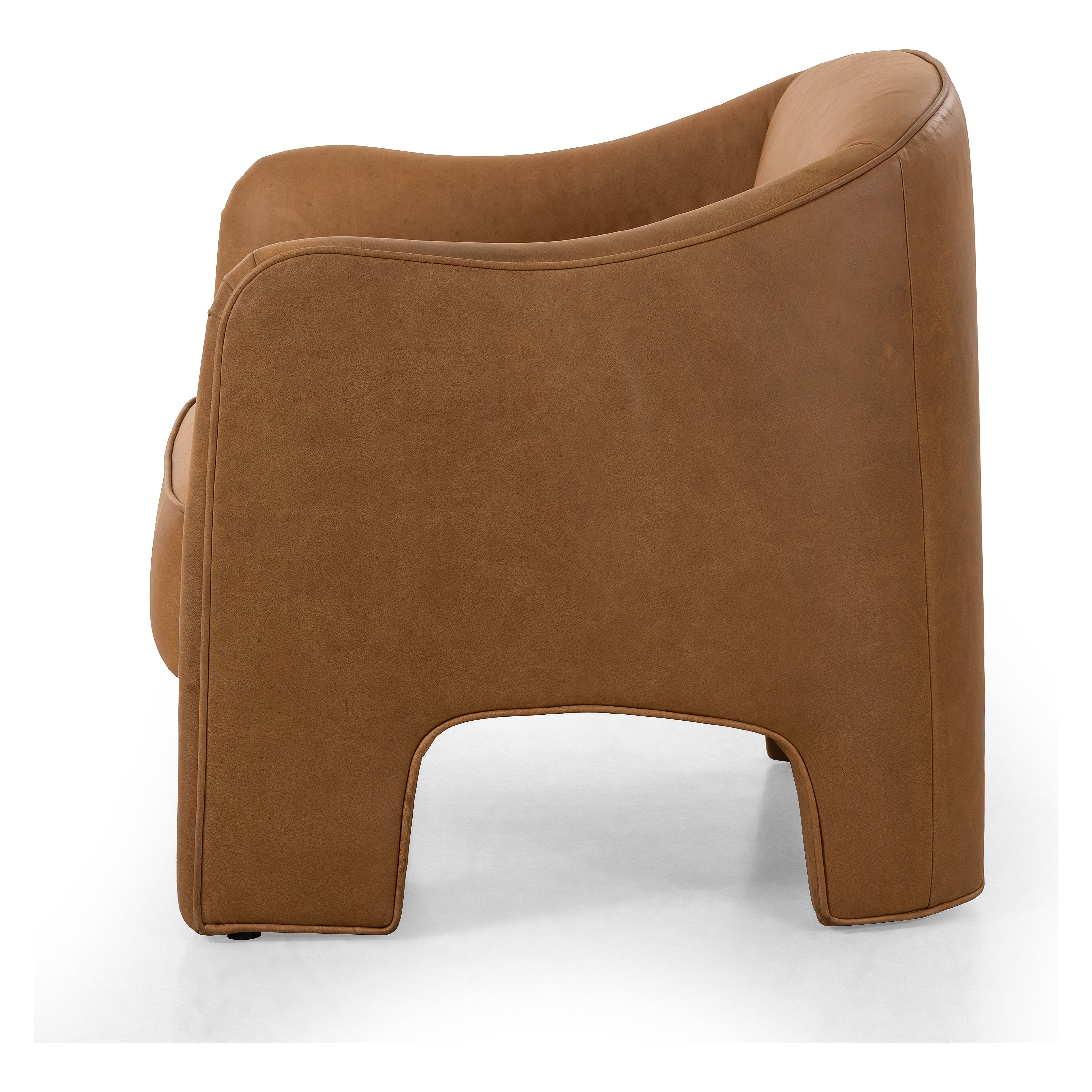 Shape-driven and sustainably made, this modern accent chair is upholstered in carbon neutral, vegetable-tanned leather processed using naturally fallen eucalyptus leaves in Uruguay. S-spring construction ensures a supportive sit, while side cutouts catch the eye. Amethyst Home provides interior design, new construction, custom furniture, and area rugs in the Kansas City metro area.