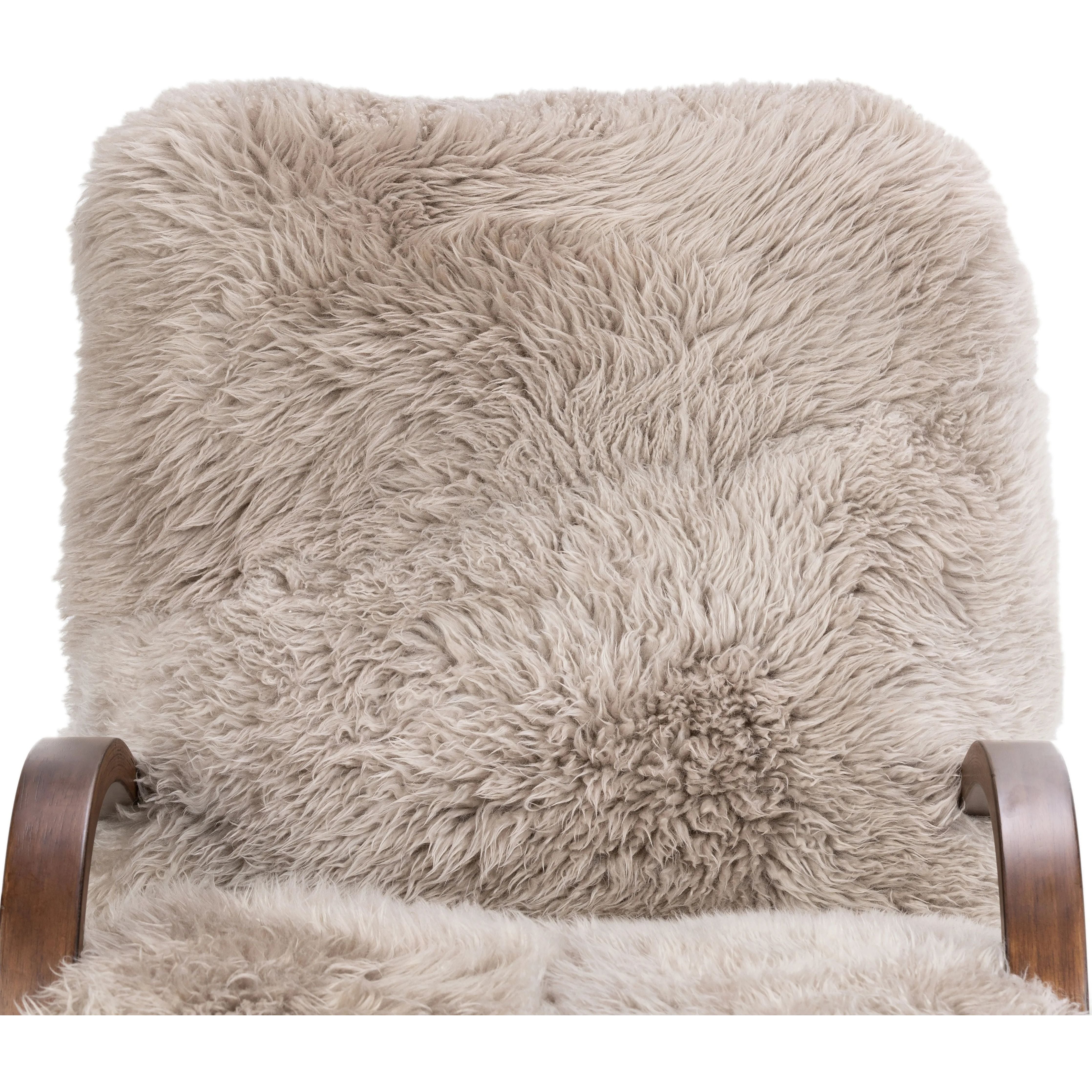 Ethically sourced authentic Mongolian sheepskin covers this unique statement chair, featuring removable feather-foam cushions. A cantilever-like wooden frame pairs with a webbed suspension seat to offer a true sink-in sit Amethyst Home provides interior design, new home construction design consulting, vintage area rugs, and lighting in the Miami metro area.