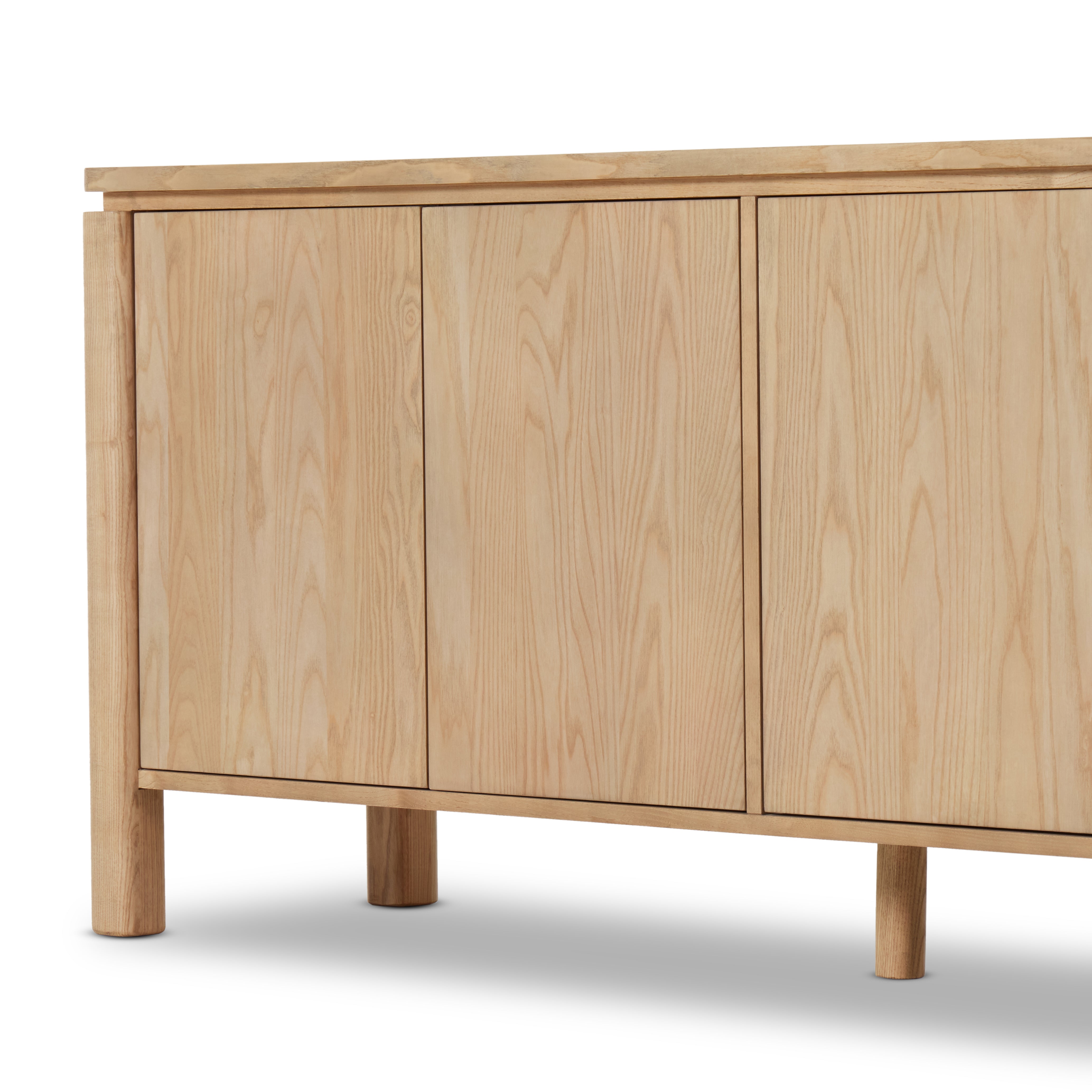 Large, rounded legs support this sleek sideboard with a reveal detail at the top. A beautiful ash finish showcases and highlights the natural wood grain. Amethyst Home provides interior design, new construction, custom furniture, and area rugs in the Portland metro area.