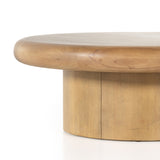 The Zach coffee table in burnished parawood features a pedestal-style base on a rounded tabletop with bullnose edging, for style and softness alike. Amethyst Home provides interior design, furniture, rugs, and design services in the New York metro area.