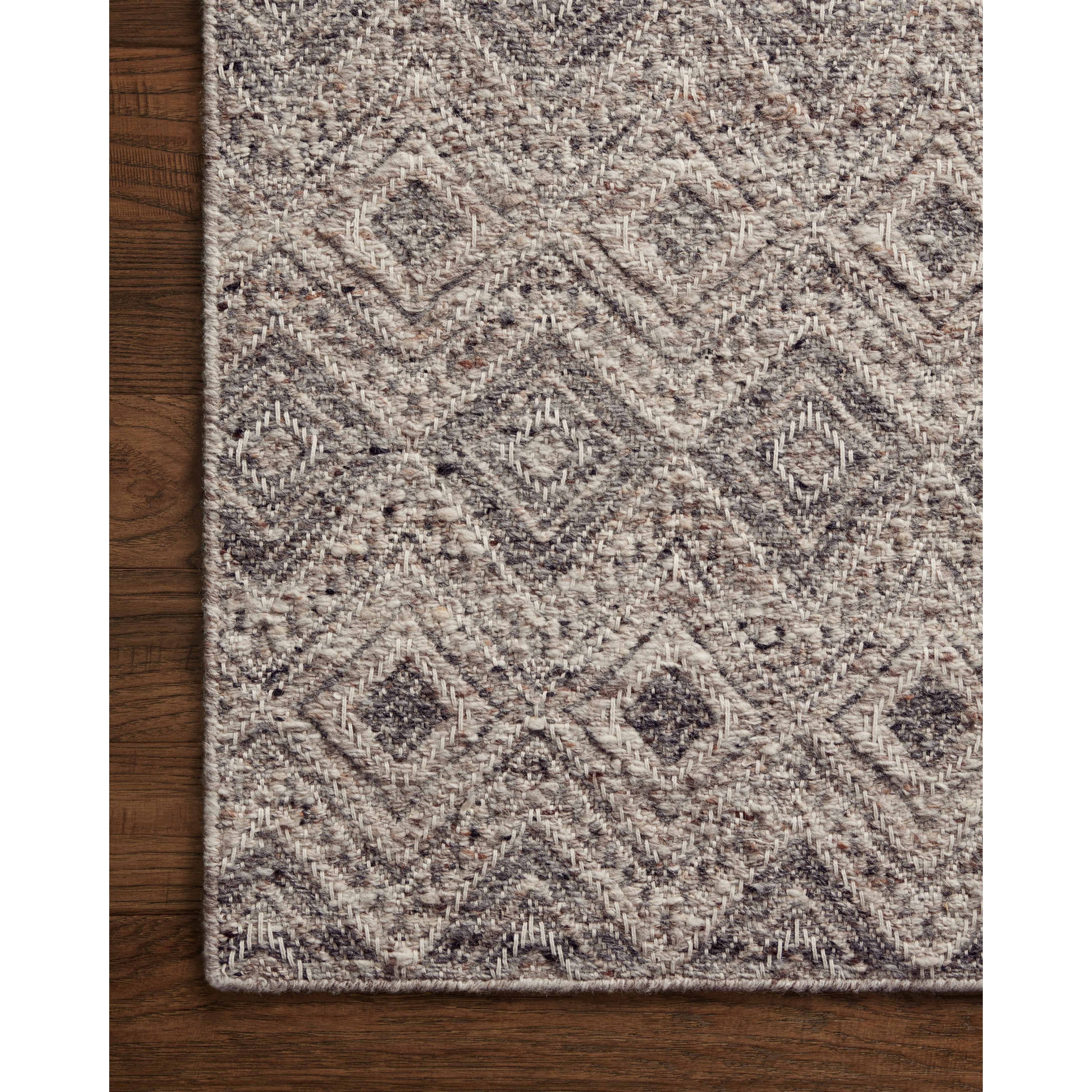 The Raven Taupe / Grey Rug is intricately handwoven with delicate, fine yarns that amplify the rug's layered and dimensional geometric design. While the rug itself is thick and sturdy, the colors and patterns have a casual lightness that can work in many spaces, from busy living rooms to serene bedrooms. Amethyst Home provides interior design, new construction, custom furniture, and area rugs in the Alpharetta metro area.