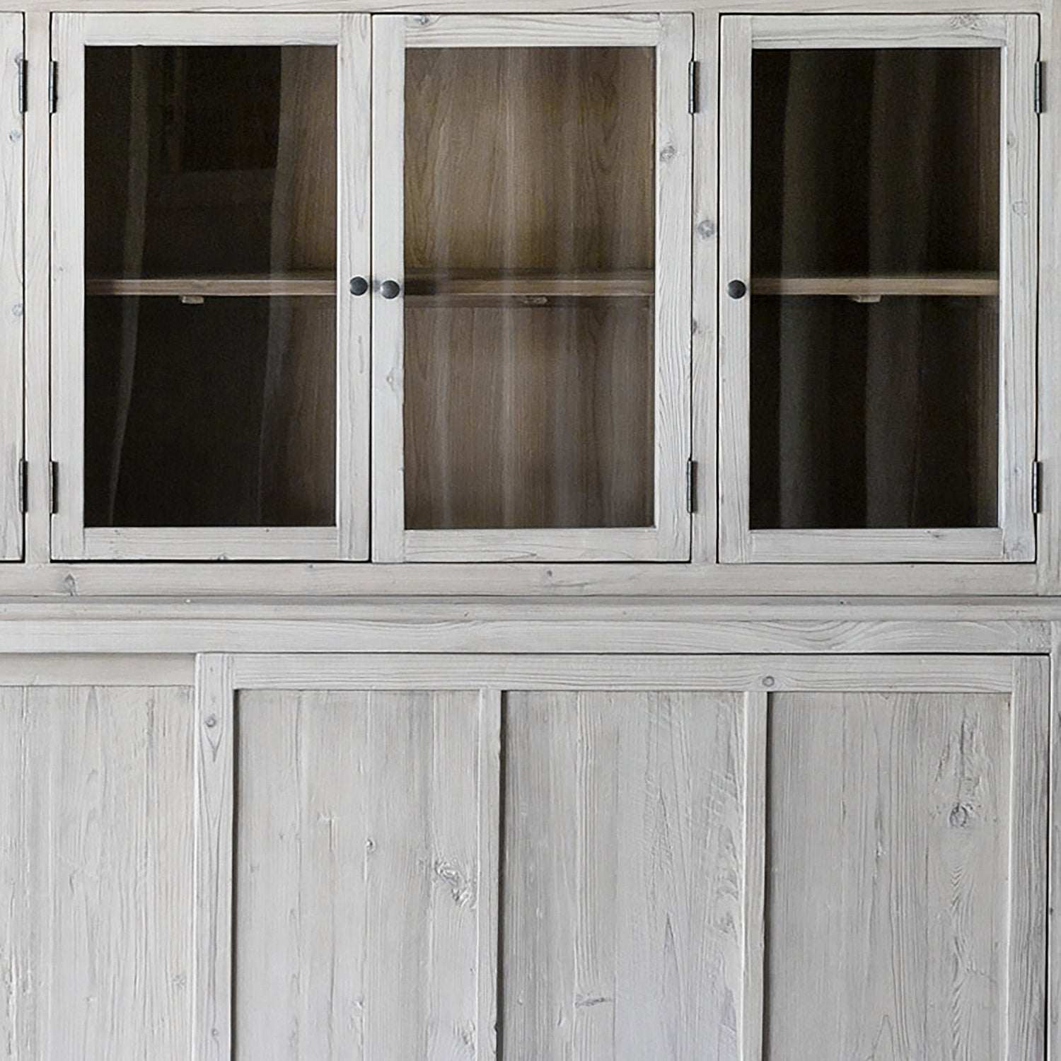 This Haley Cabinet has ample storage, with glass door panels opening to shelves and a bottom sliding door that opens to more shelves. Made from reclaimed pine with a white wash grey sealed finish, this brings an antique feel to any room. Reclaimed Pine White Wash Grey Sealed Finish Flat Glass Door Panels