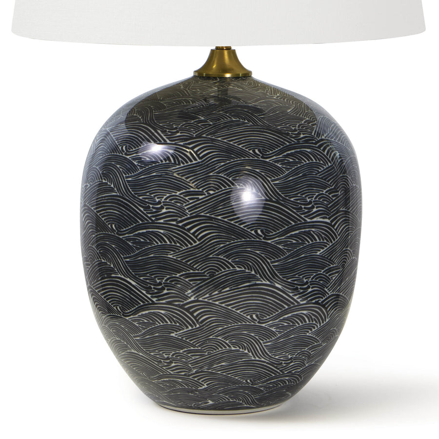 This Harbor Ceramic Table Lamp by Regina Andrew features a specialized glazing technique that highlights the gorgeous pattern in shades of black or blue. The natural linen shade brings a warm, sophisticated look to any living room, bedroom, or other area needing.  Overall Dimension: 18"w x 18"d x 29"h 