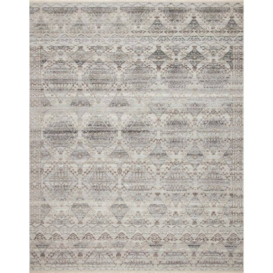Both timeless and modern, the Idris Stone area rug from Loloi is meticulously hand-knotted in colors of grey, ivory, and blue. The tonal series features an elevated texture, accentuating the detailed pattern. The Idris Stone rug, also known as ID-01 Stone, is hand-knotted of 70% Viscose and 30% Wool.