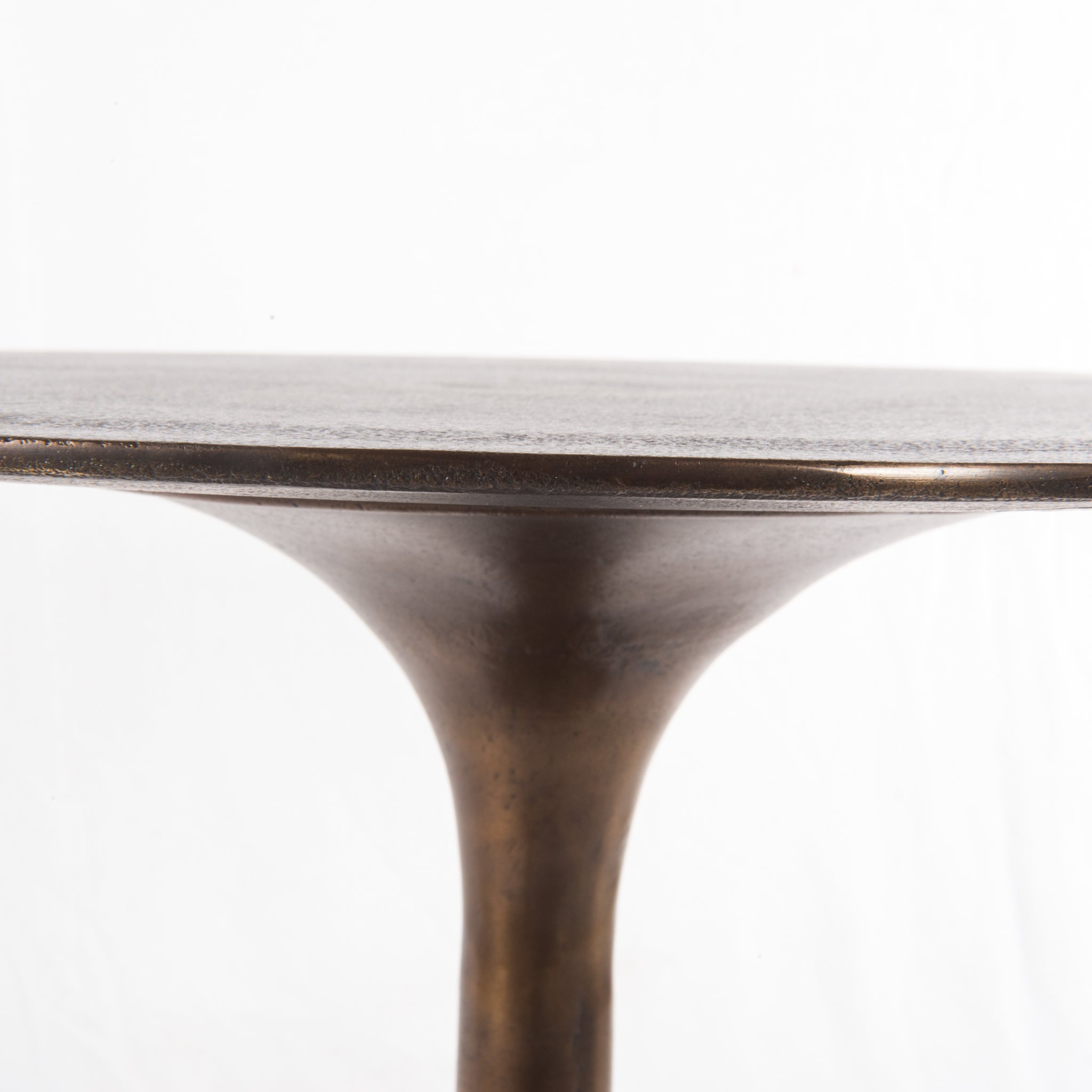 Classic tulip shaping in textural cast-aluminum makes for a modern side table. Finished in antique rust to bring out alluring highs and lows. Great indoors or out — cover or store indoors during inclement weather and when not in use.  Overall Size: 20.00"w x 20.00"d x 23.50"h