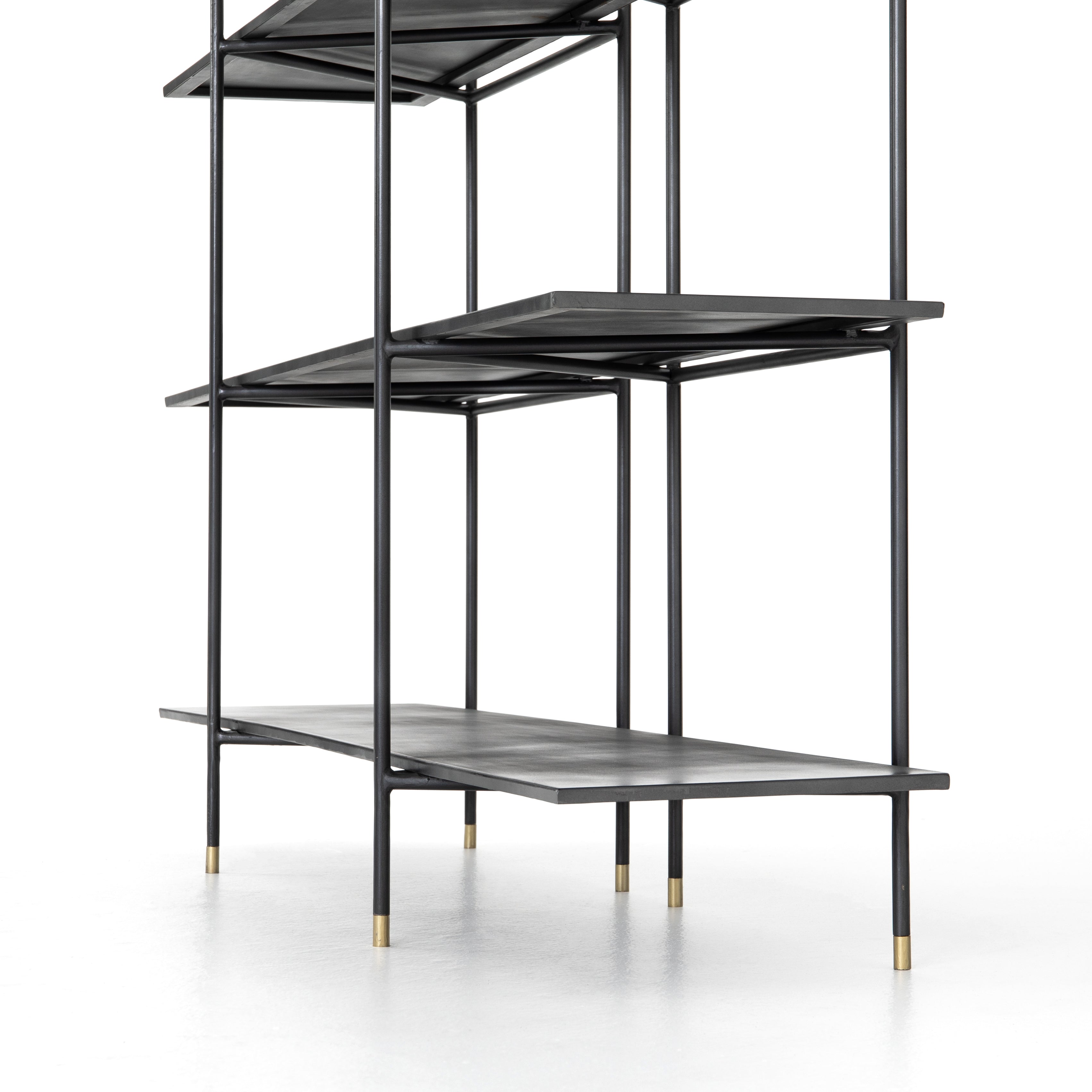 Modern industrial design gets softened by fine lines with this Vito Bookshelf. Wide planks of distressed iron offer plenty of space for the display of books and treasured items. Brass-capped feet add a feminine finishing touch.  Available September 2020!  Overall Dimensions: 63"w x 16.5"d x 71"h Materials: Iron