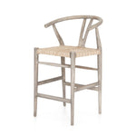 Modern curves redefine the classic wishbone-style counter stool. Vintage white all-weather wicker is woven for a dose of fresh texture within weathered grey teak framing. Cover or store indoors during inclement weather and when not in use.  Pictured in Weathered Grey. Also available in Black Teak and Matte Sealed Teak.  Overall Size: 21.50"w x 22.50"d x 38.50"h Seat Depth: 18.25" Seat Height: 26.50"