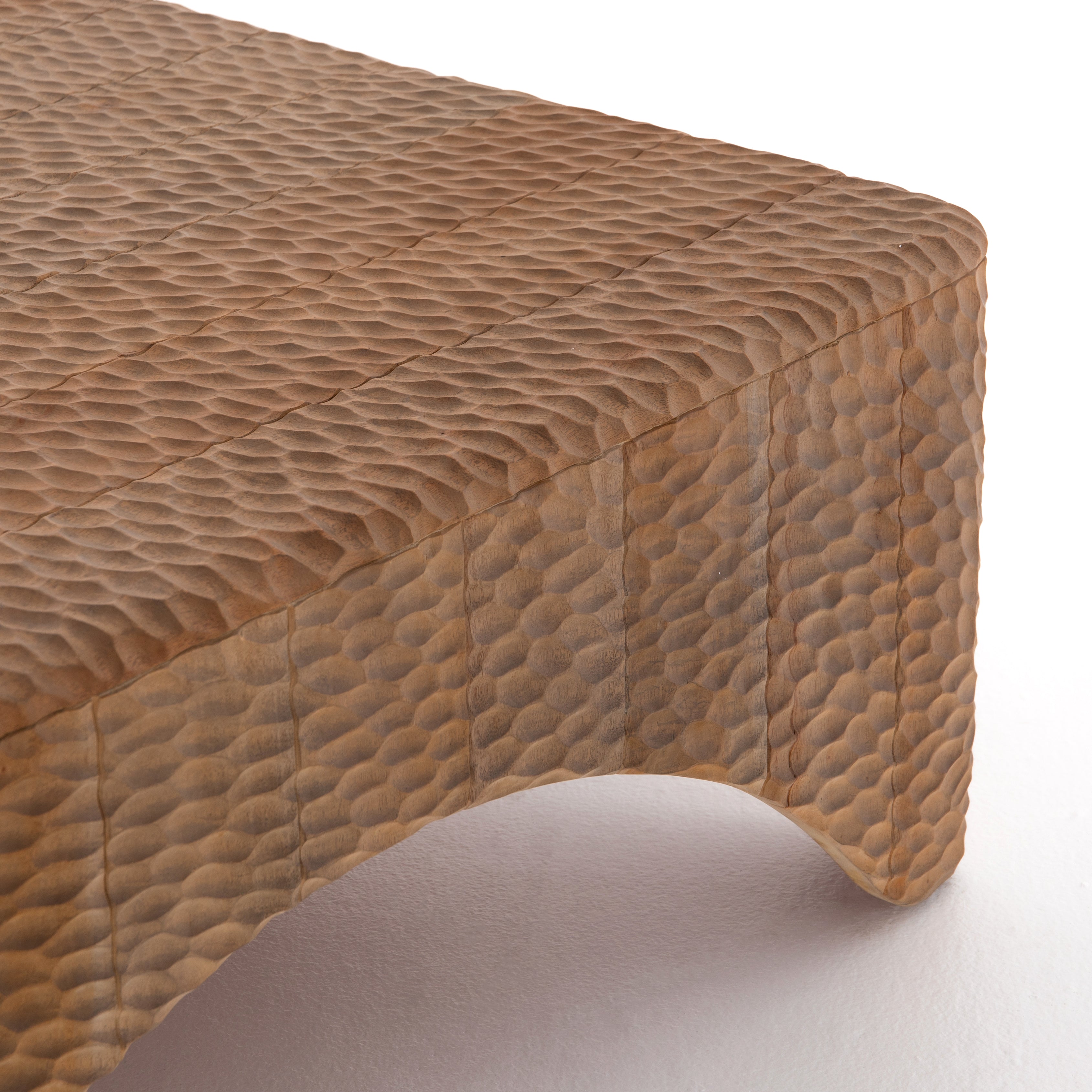 Inspired by rare 18th-century sake flasks, Atrumed Coffee Table is solid mahogany thoughtfully hand carved, creating a textural, dimple-like look with warm, sun-bleached undertones. Unique variations to be expected, and speak to this piece's handmade nature.  Available Mid September 2020.   Overall Dimensions: 40"w x 40"d x 16"h Materials: Mahogany