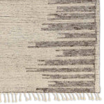 Featuring Alpine Patra Hand-Knotted Rug by Jaipur Living at Amethyst Home. Inspired by textiles from the Tullu region in Morocco, the Patra area rug showcases a linear design in neutral shades of cream, taupe, brown, and gray. This high-piled accent lends warmth and comfort to any space with durable wool hand-knotted onto a cotton foundation. Braided fringe. Amethyst Home provides interior design, new home construction design consulting, vintage area rugs, and lighting in the Charlotte metro area.