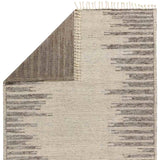 Inspired by textiles from the Tullu region in Morocco, the Patra area rug showcases a linear design in neutral shades of cream, taupe, brown, and gray. This high-piled accent lends warmth and comfort to any space with durable wool hand-knotted onto a cotton foundation. Braided fringe trims the edges for a touch of boho charm. Amethyst Home provides interior design, new home construction design consulting, vintage area rugs, and lighting in the Tampa metro area.