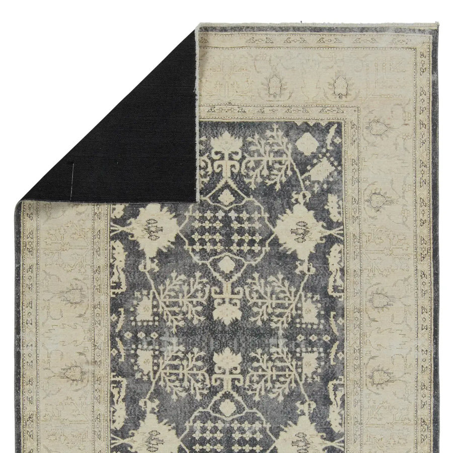 The Boheme Pia Rug brings vintage inspiration to life with ornate, worldly designs and a timeless distress effect. The Pia area rug boasts a Persian-inspired center medallion, short fringe and detail-rich border in a navy, cream, gray, and pastel green colorway. Amethyst Home provides interior design services, furniture, rugs, and lighting in the Kansas City metro area.