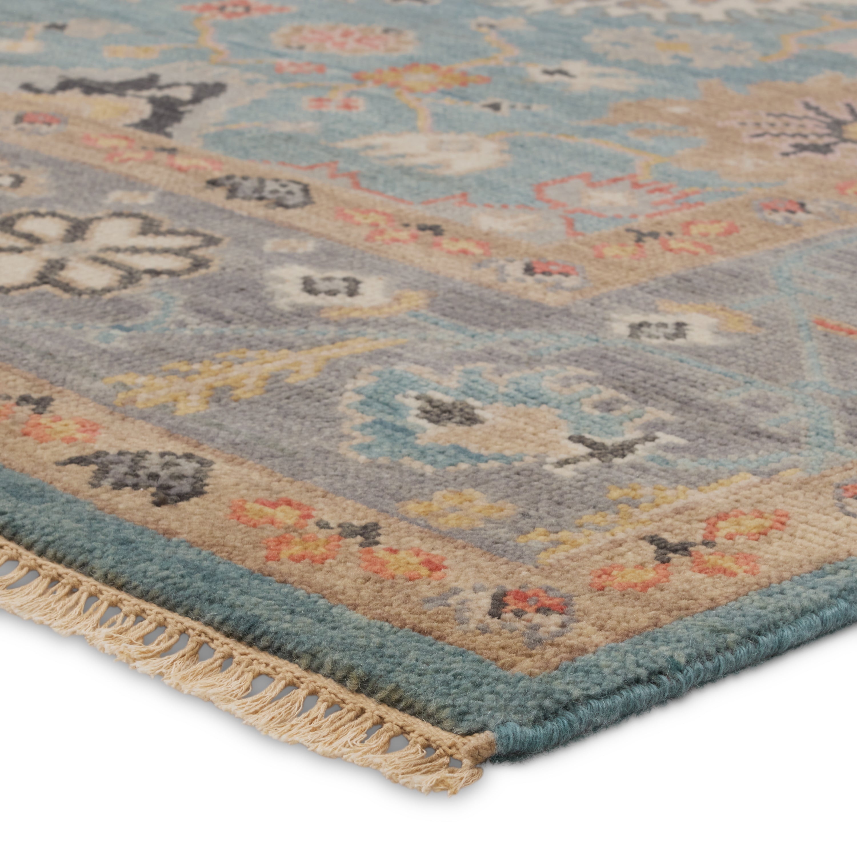 The updated traditional Everly collection features Oushak-inspired designs in whimsical color palettes. The Aloft design features a lively colorway of blue, pink, yellow, navy, cream, peach, and taupe. This hand-knotted wool rug anchors living spaces with a fresh take on vintage style. The low, easy-care pile delights in both high and low traffic areas of the home.  Amethyst Home provides interior design, new construction, custom furniture, and area rugs in the Seattle metro area.