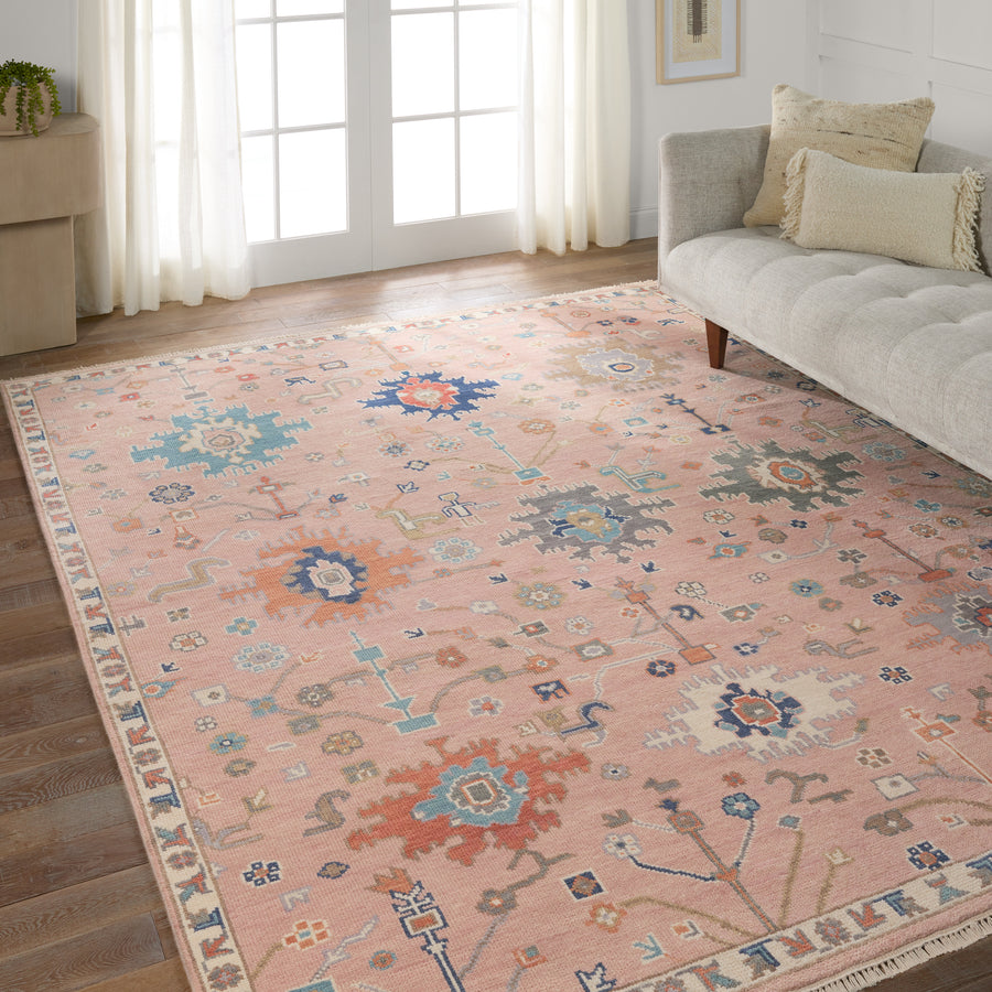The updated traditional Everly collection features Oushak-inspired designs in whimsical color palettes. The Matera design features a sweet colorway of pink, yellow, navy, cream, peach, and taupe. This hand-knotted wool rug anchors living spaces with a fresh take on vintage style. The low, easy-care pile delights in both high and low traffic areas of the home.  Amethyst Home provides interior design, new construction, custom furniture, and area rugs in the Omaha metro area.