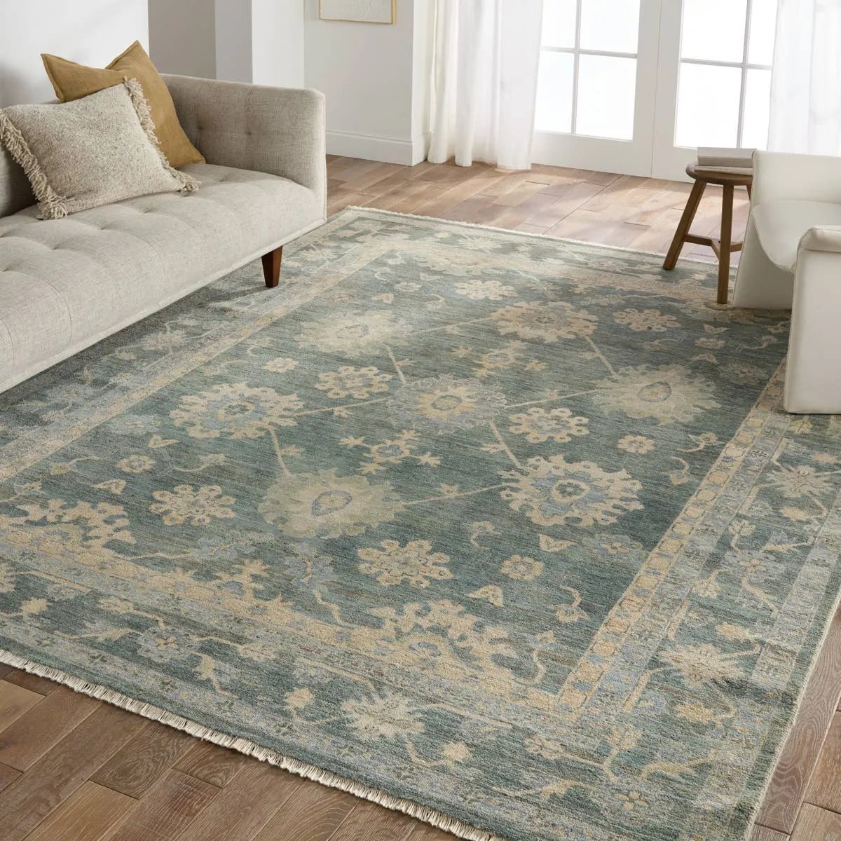 The Orenda Kerensa features heirloom-quality designs of muted and uniquely updated Old World patterns. The Kerensa area rug boasts a beautifully washed medallion motif with an antique Oushak-inspired vibe. The cream tone is accented with cool blues, greens, and warm beige hues for added depth and intrigue. Amethyst Home provides interior design, new home construction design consulting, vintage area rugs, and lighting in the Newport Beach metro area.