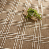 The indoor-outdoor Paradizo collection features durable, weather-resistant fibers that create a flatwoven, natural look. Emanating the colors and tone of grass fibers, the Barrett rug boasts a neutral, grounding palette. The textural grid design paired with the colorway of brown and cream highlight the easily styled nature of this accent piece. Amethyst Home provides interior design, new home construction design consulting, vintage area rugs, and lighting in the Austin metro area.