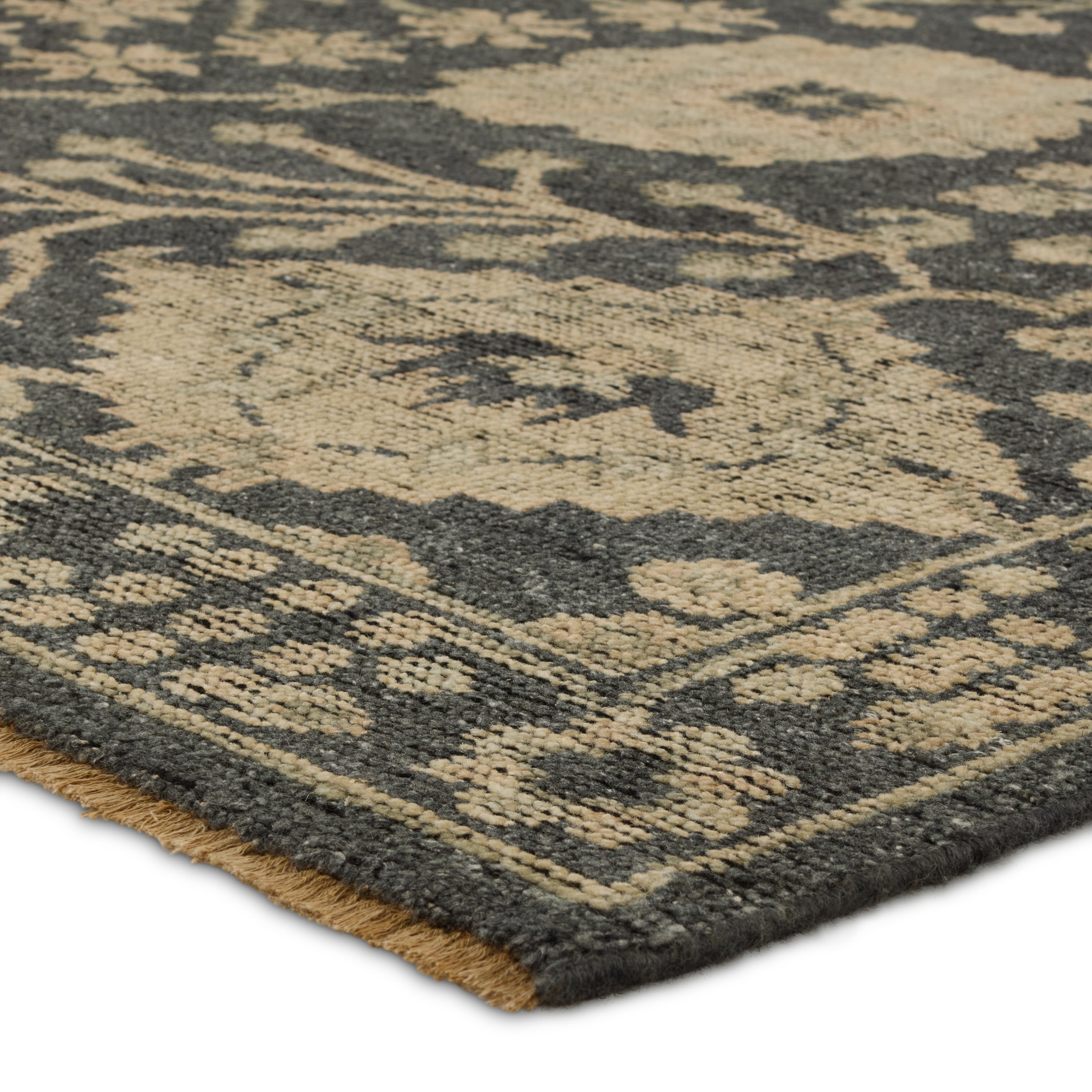 The Rhapsody collection features heirloom-quality designs of stunningly abrashed Old World patterns. The Maeli area rug boasts a beautifully washed Oushak motif with a decorative border. The dark gray tones are accented with khaki, cream, green, and beige hues for added depth and intrigue. This durable wool handknot anchors living spaces with a fresh take on vintage style. Amethyst Home provides interior design, new construction, custom furniture, and area rugs in the Des Moines metro area.