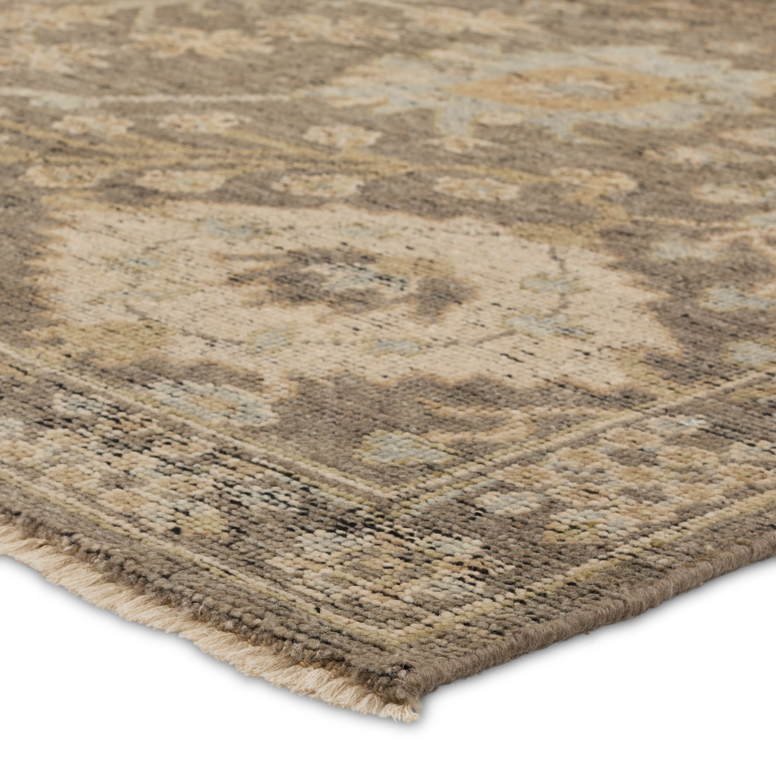 The Rhapsody collection features heirloom-quality designs of stunningly abrashed Old World patterns. The Maeli area rug boasts a beautifully washed Oushak motif with a decorative border. The gray tones are accented with cream, black, brown, and green hues for added depth and intrigue. This durable wool handknot anchors living spaces with a fresh take on vintage style. Amethyst Home provides interior design, new construction, custom furniture, and area rugs in the Miami metro area.