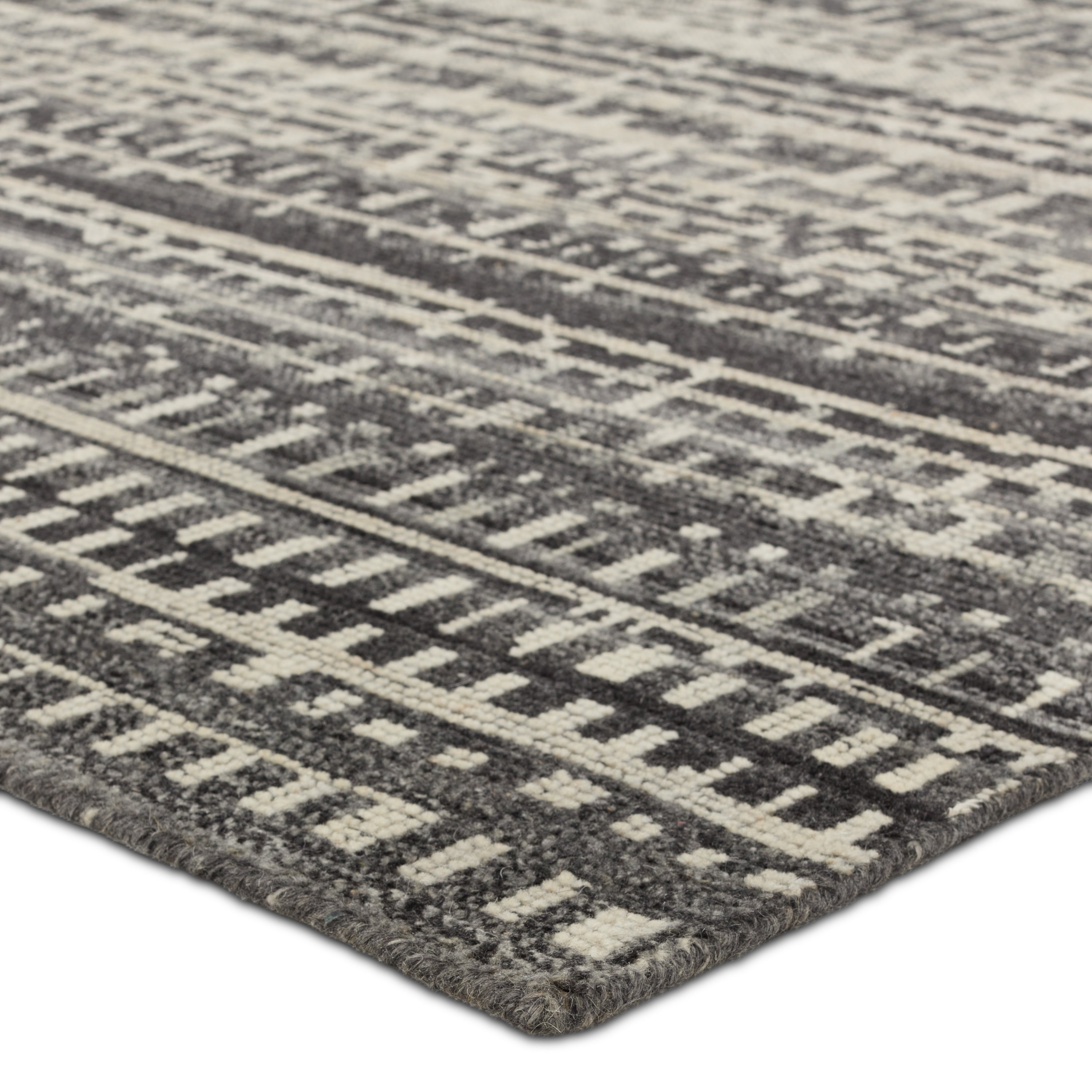 The Rize collection offers intricate and delicately designed global patterns to the modern home. The luxurious Jamaal area rug showcases a striped, linear motif in a classic gray, cream, and black colorway. This accent's hand-knotted wool construction ensures timeless durability and a stunning presence in bohemian spaces.  Amethyst Home provides interior design, new construction, custom furniture, and area rugs in the Dallas metro area.
