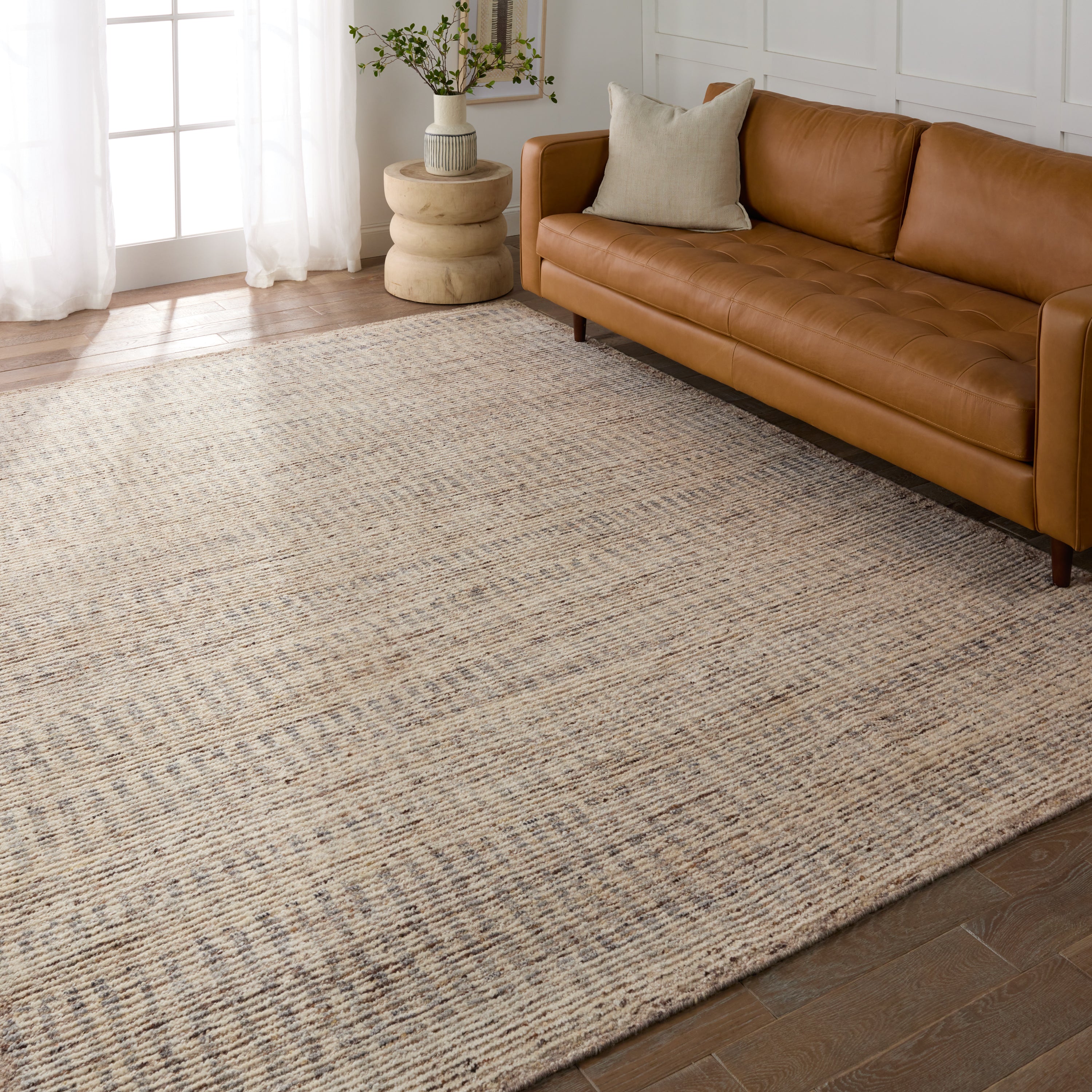 Subtle linear textures and natural colorways define the irresistible quality of the Seora collection. The Camino area rug features a series of perpendicular, striped lines for an intriguing dose of modern appeal. The textural, wool pile contains no dye, reflecting the natural colors of the sheep, for a rich and grounding palette of tan, cream, and flecks of brown and gray.  Amethyst Home provides interior design, new construction, custom furniture, and area rugs in the Scottsdale metro area.