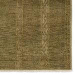 The hand-knotted Tapeten Achala features globally inspired designs that evoke a balance of tradition and modernity. The Achala pattern stuns with a high-low effect that distinguishes the olive green, geometric, striped pattern. Amethyst Home provides interior design, new home construction design consulting, vintage area rugs, and lighting in the Kansas City metro area.