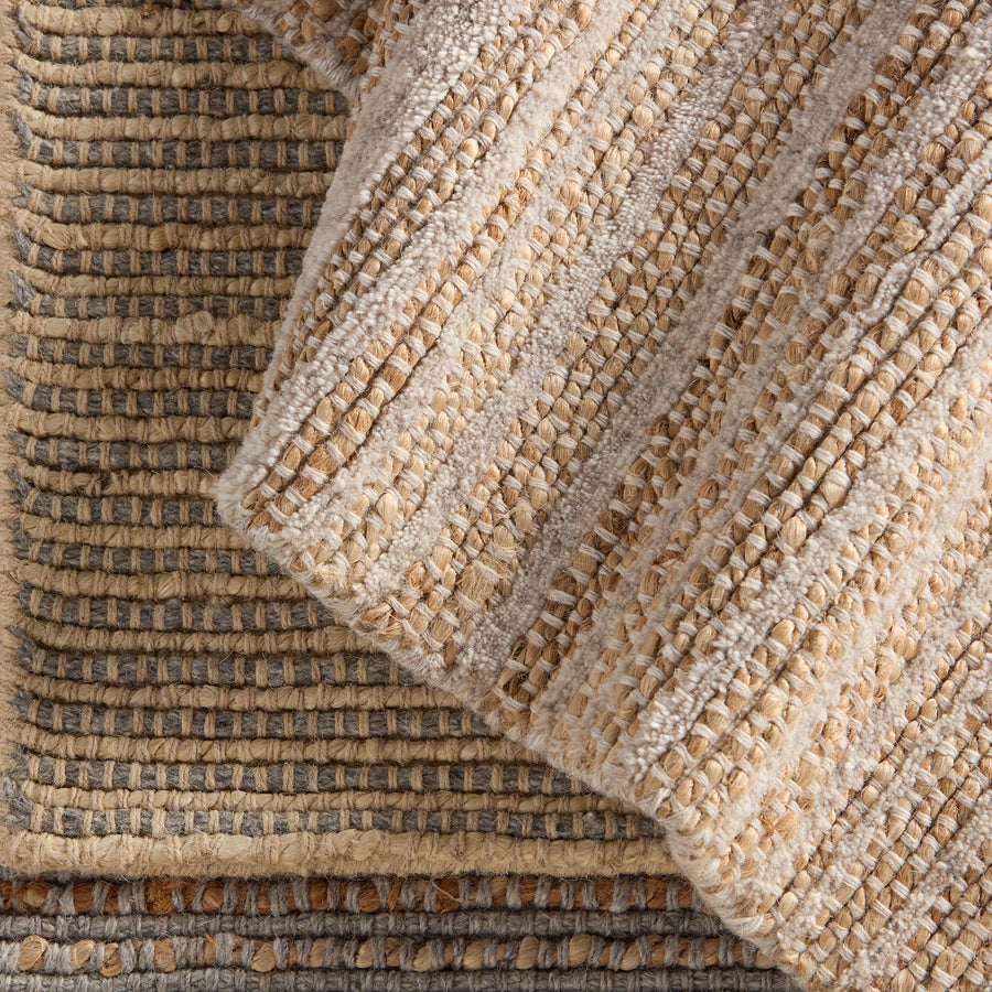 The Topo collection is infused with beautiful texture created by natural jute and soft wool and cotton yarns. The combination of these natural fibers anchors a space with warmth and versatility. The Latona design features alternating fibers for a striped pattern in hues of gray and tan. This area rug is best suited for indoor, low traffic areas of the home. Amethyst Home provides interior design, new construction, custom furniture, and area rugs in the Calabasas metro area.