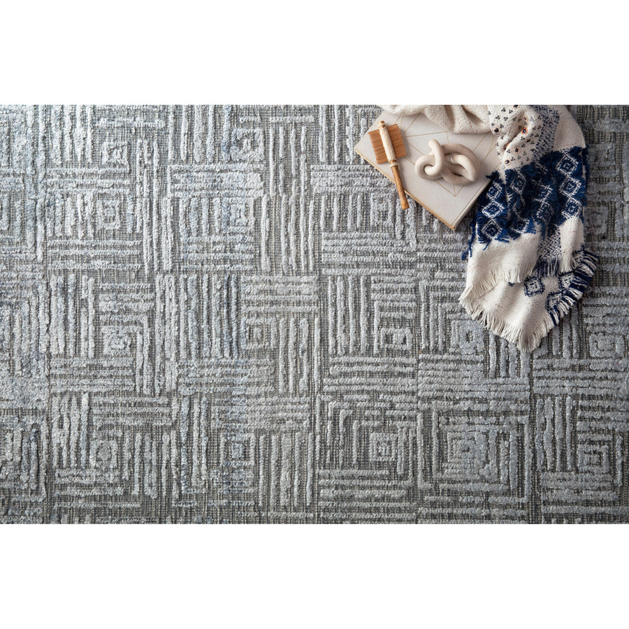 Featuring tone on tone geometric patterns, the Lana Denim Area Rug is hand-knotted of wool, viscose and cotton. Crafted in India, the refined high-low pile is a testament to the dedication of craftsmanship required to create each rug. This would go great in a living room, kitchen, or other medium to high-traffic areas. 