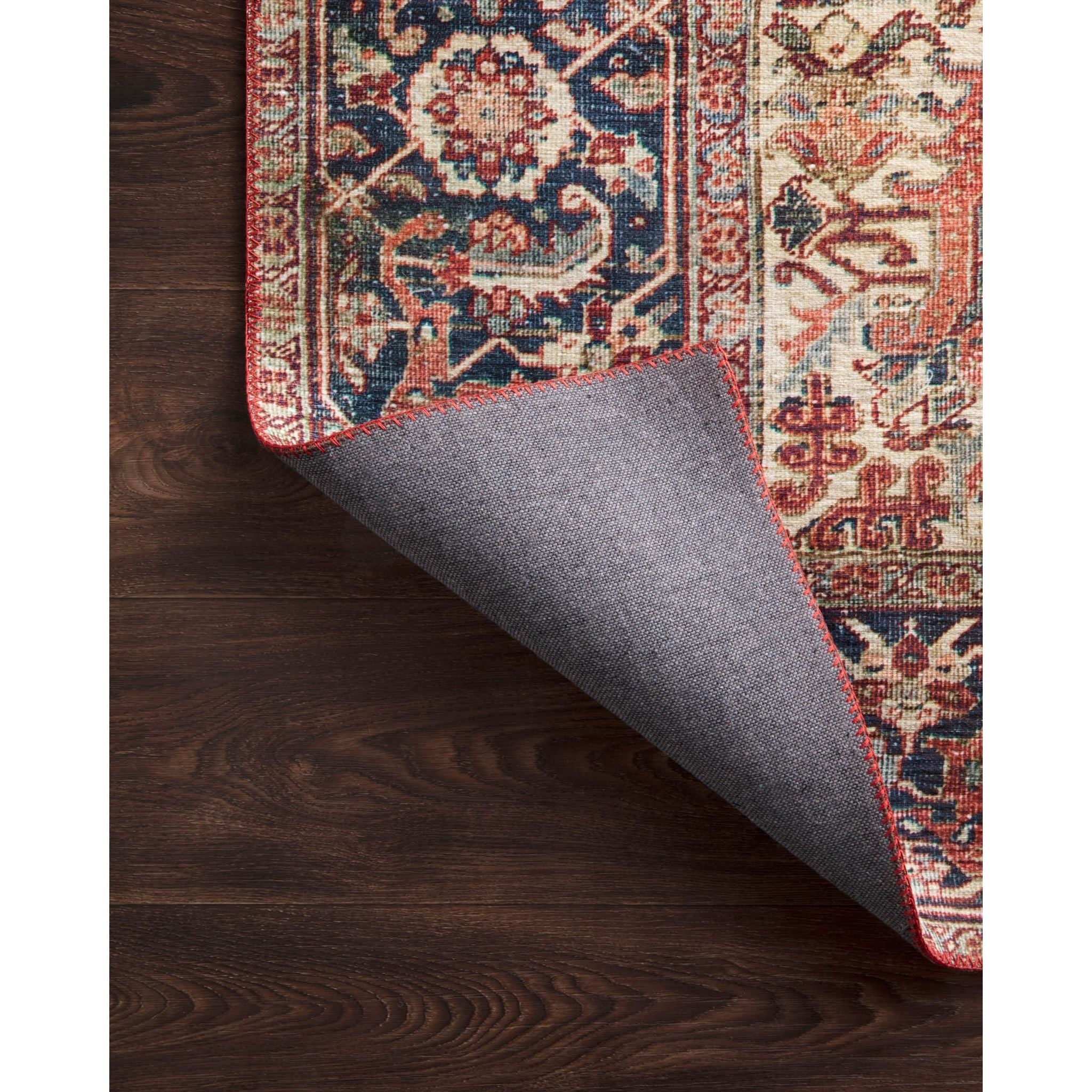 The Layla rug collection from Loloi is traditional and timeless, with a beautiful lived-in design in the spirit of an old-world rug. The Layla Red/Navy area rug is power-loomed of 100% polyester for heavy foot traffic. The rug is a classic with a sophisticated and subtle patina in red, navy, blue, and ivory.