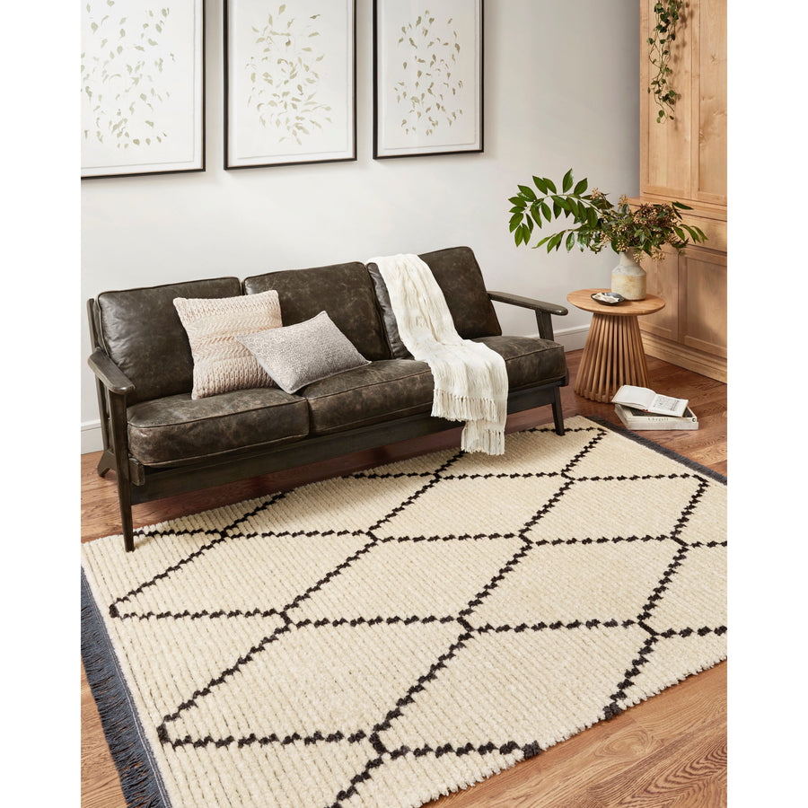 Durable, graphic, and soft underfoot, this rug is inspired by the classic Moroccan rug. The Alice Chris + Julia Cream / Charcoal ALI-04 rug features a high-low texture with warm earthy colors with a subtle fringe. The rug is easy to clean and maintain and perfect for living rooms, dining rooms, hallways, and kitchens!