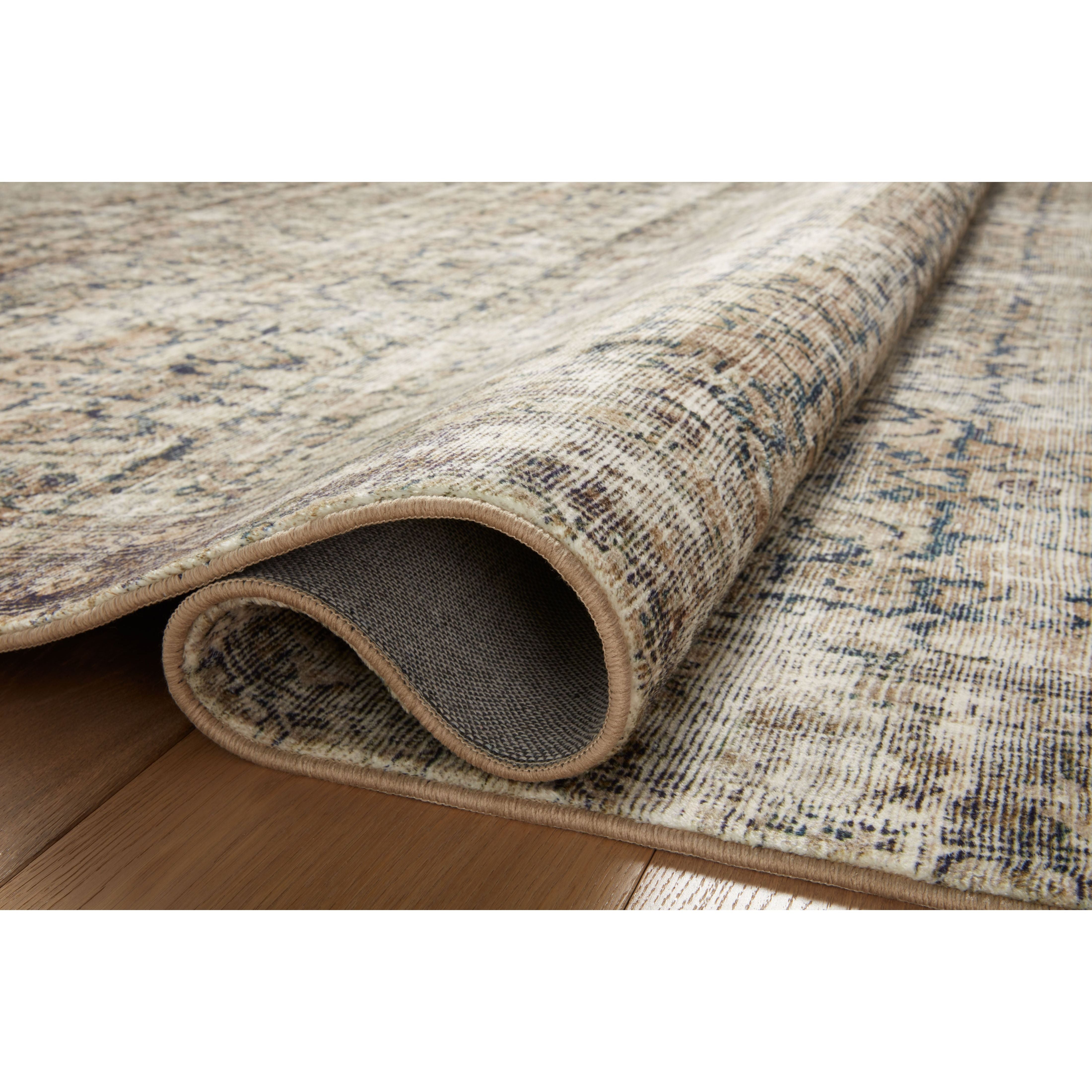 With the faded feel of an antique rug, the Amber Lewis x Loloi Morgan Navy / Sand Rug is a feat of modern printed construction. These impressive area rugs expertly blend sophisticated tones to recreate the dynamic colors of a vintage textiles. Power-loomed of CloudPile™ construction, these rugs are extra-soft to walk upon yet still durable for high-traffic rooms. Amethyst Home provides interior design services, furniture, rugs, and lighting in the Calabasas metro area.