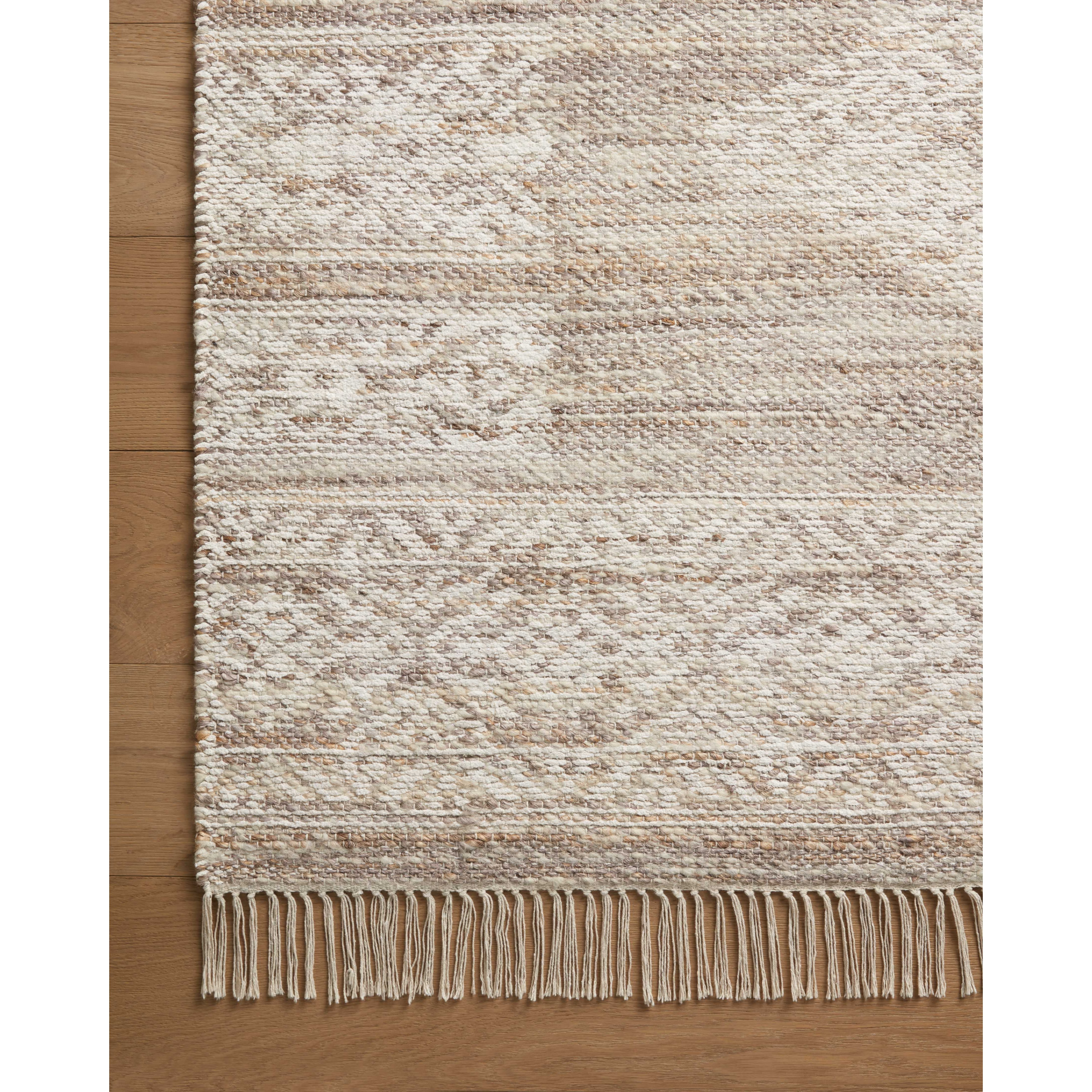 The Rivers Collection by Angela Rose x Loloi is a modern flatweave area rug with a reversible design featuring symmetrical motifs. Woven of wool, cotton, and jute, Rivers combines natural materials with an airy, natural aesthetic. The soft colors of the rug create a watercolor effect that adds artful depth to the neutral palette. Amethyst Home provides interior design, new home construction design consulting, vintage area rugs, and lighting in the Seattle metro area.