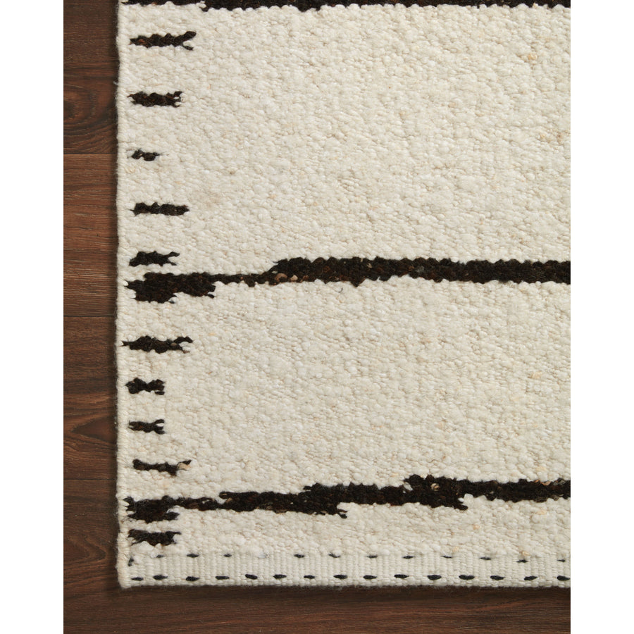 A perfect blend of refined and relaxed, the Roman Ivory / Black ROM-05 rug from Loloi is hand woven of wool, cotton and viscose by skilled artisans. Designs with meticulously placed strokes elevate any area such as an entryway, living room, dining room, or bedroom. Each piece is finished with a unique stitched edge. Amethyst Home provides interior design, new construction, custom furniture, and rugs for the Des Moines and Cedar Rapids, Iowa metro area.