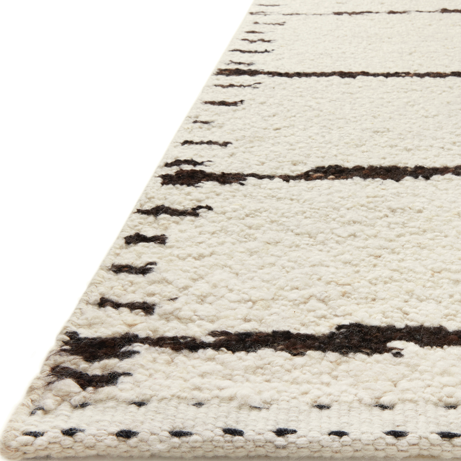 A perfect blend of refined and relaxed, the Roman Ivory / Black ROM-05 rug from Loloi is hand woven of wool, cotton and viscose by skilled artisans. Designs with meticulously placed strokes elevate any area such as an entryway, living room, dining room, or bedroom. Each piece is finished with a unique stitched edge. Amethyst Home provides interior design, new construction, custom furniture, and rugs for the Kansas City metro area.